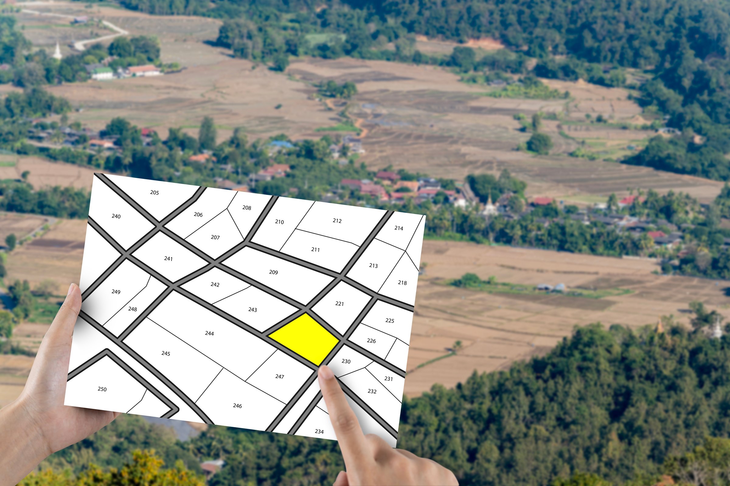 Man holding lots of land, land lot management, real estate concept with vacant land for building construction and residential subdivision for sale, rent, buy or investment.