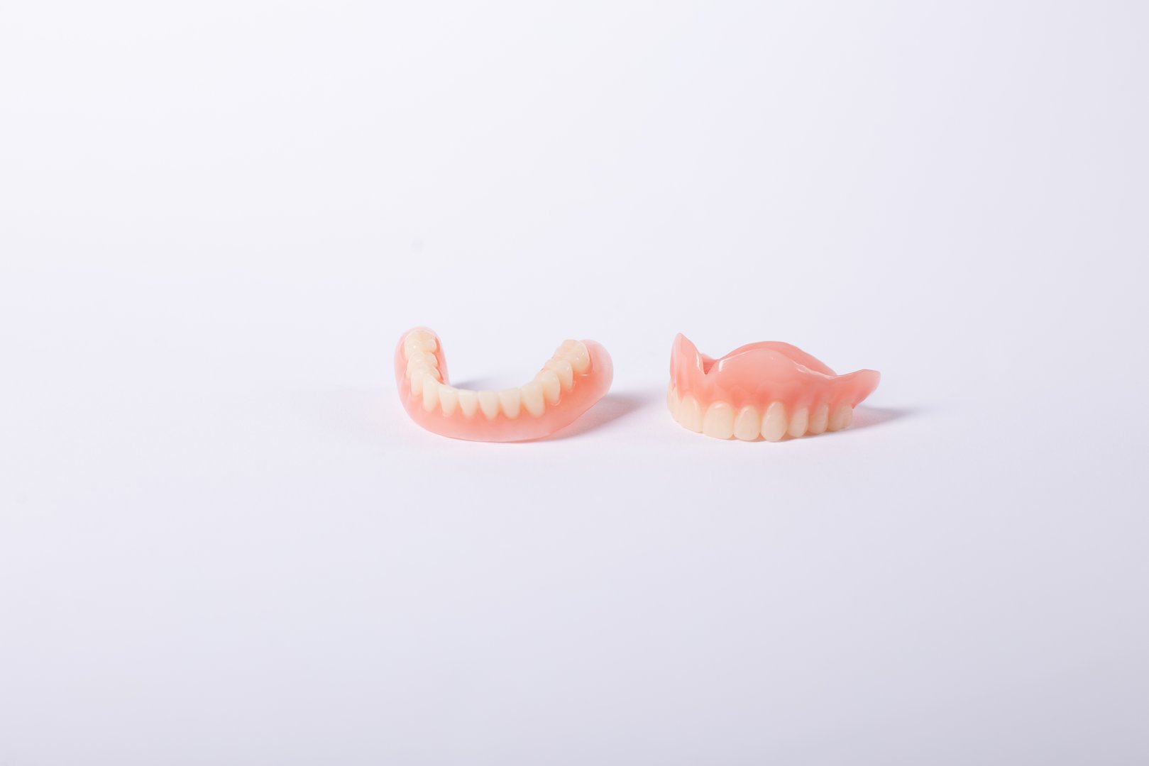 Full removable plastic denture of the jaws on white background