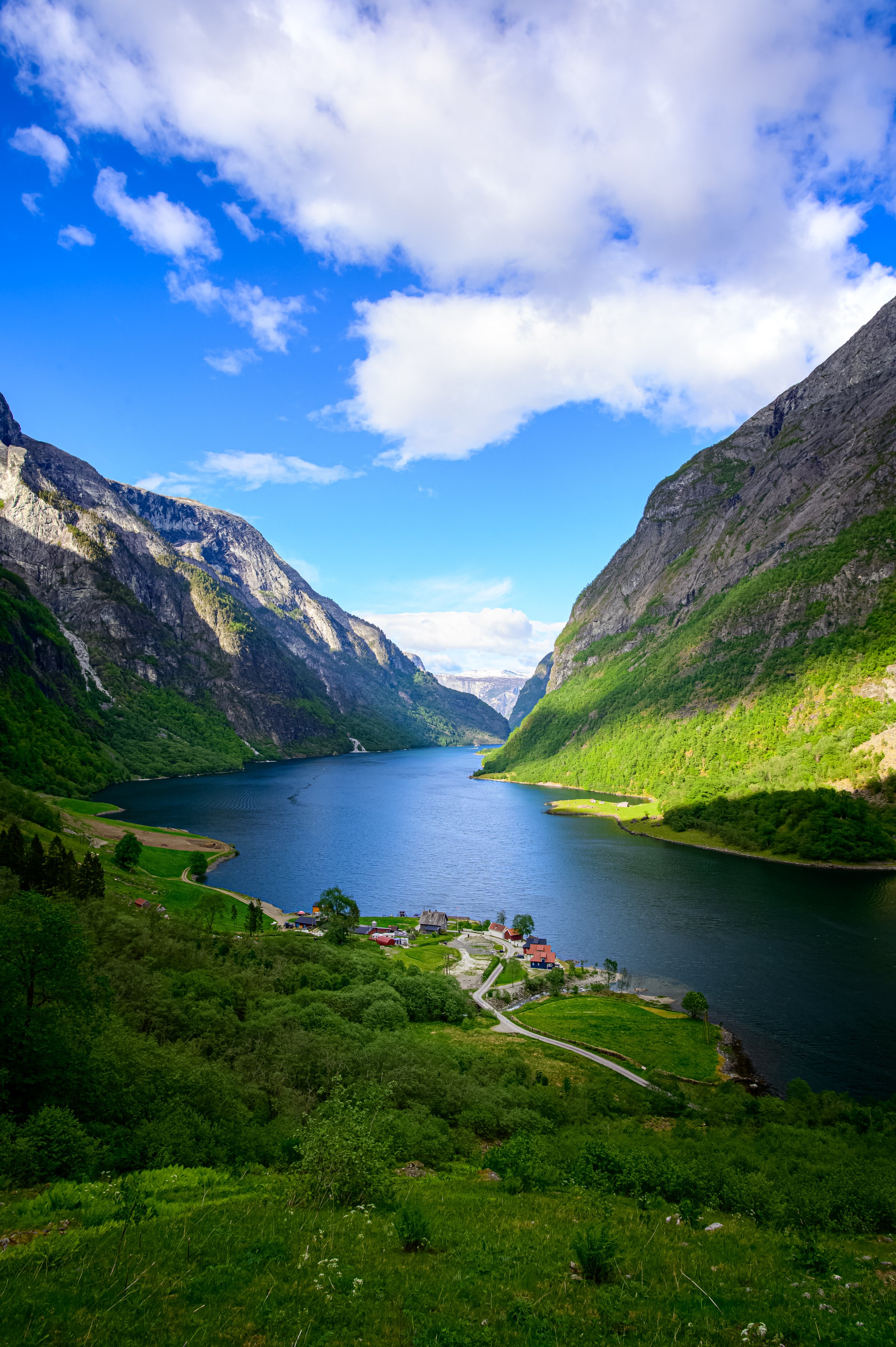 Breathtaking view of a Norwegian fjord enclosed by dramatic mountains on either side.