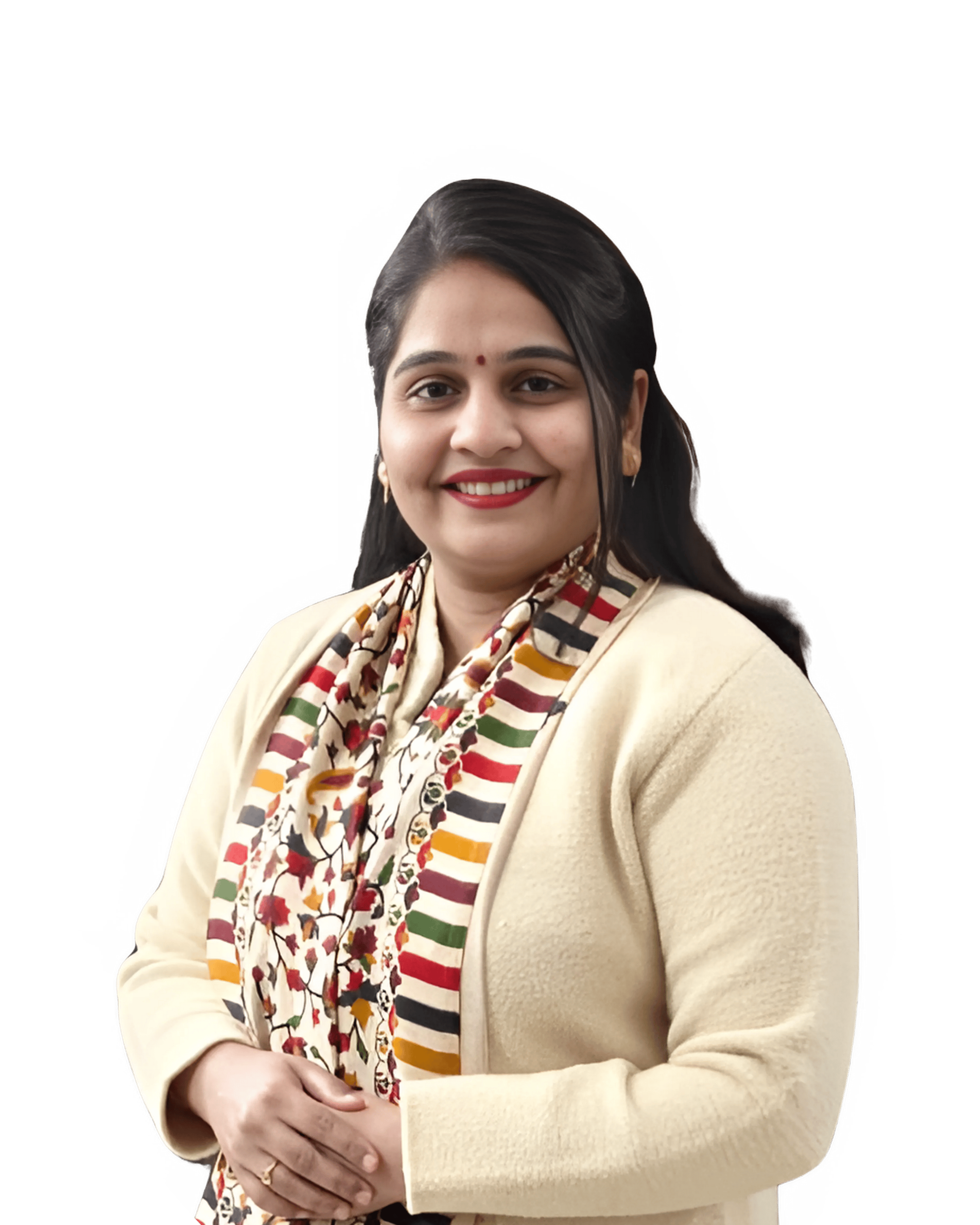 A smiling woman in a beige cardigan and colorful scarf stands against a plain background.