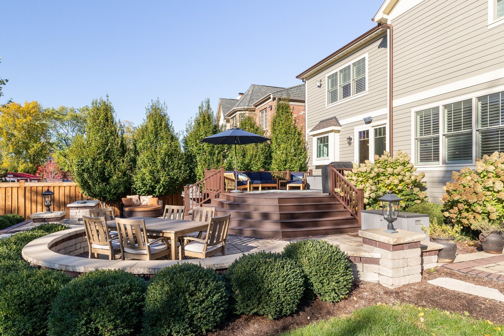 Oak Park, IL, USA - November 4, 2021: Backyard of a luxury modern farmhouse with a multiple level patio with different seating areas.