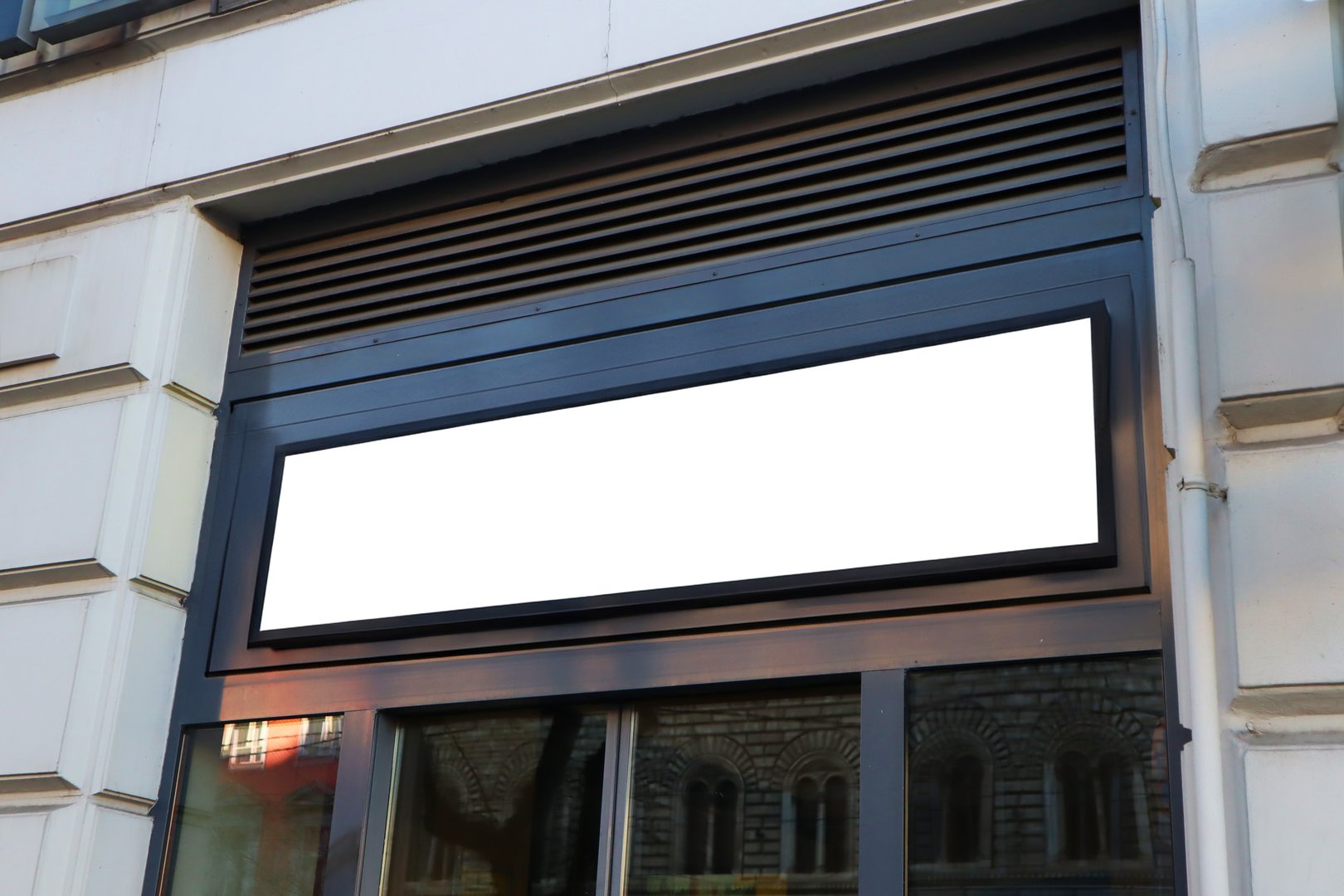 Blank billboard sign mockup in the urban environment on old building, facade, empty space to display your advertising or branding campaign