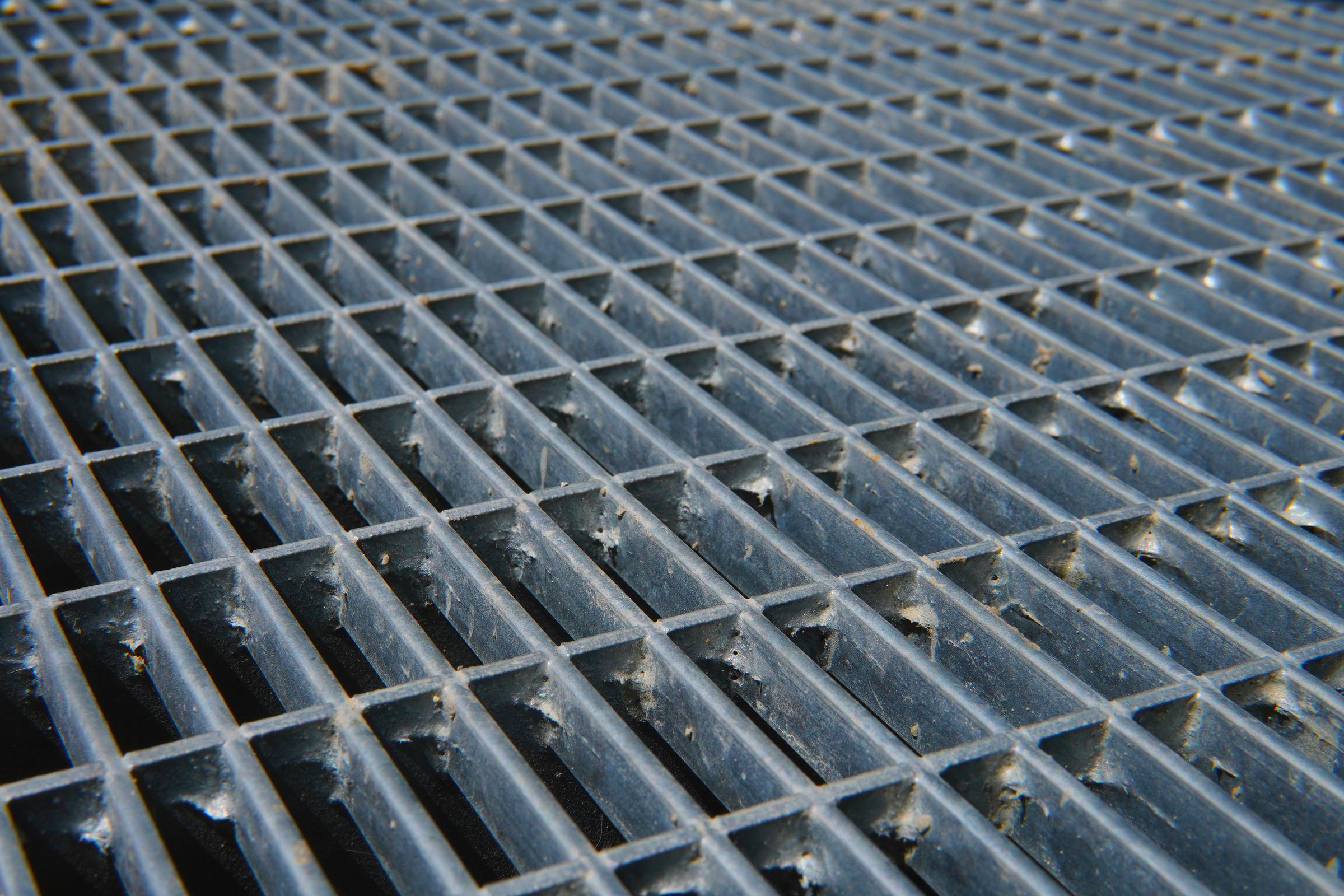 New Galvanized Steel Pathway Mesh. Durable metal mesh with a rough texture. Industrial steel construction provides durability and drainage.