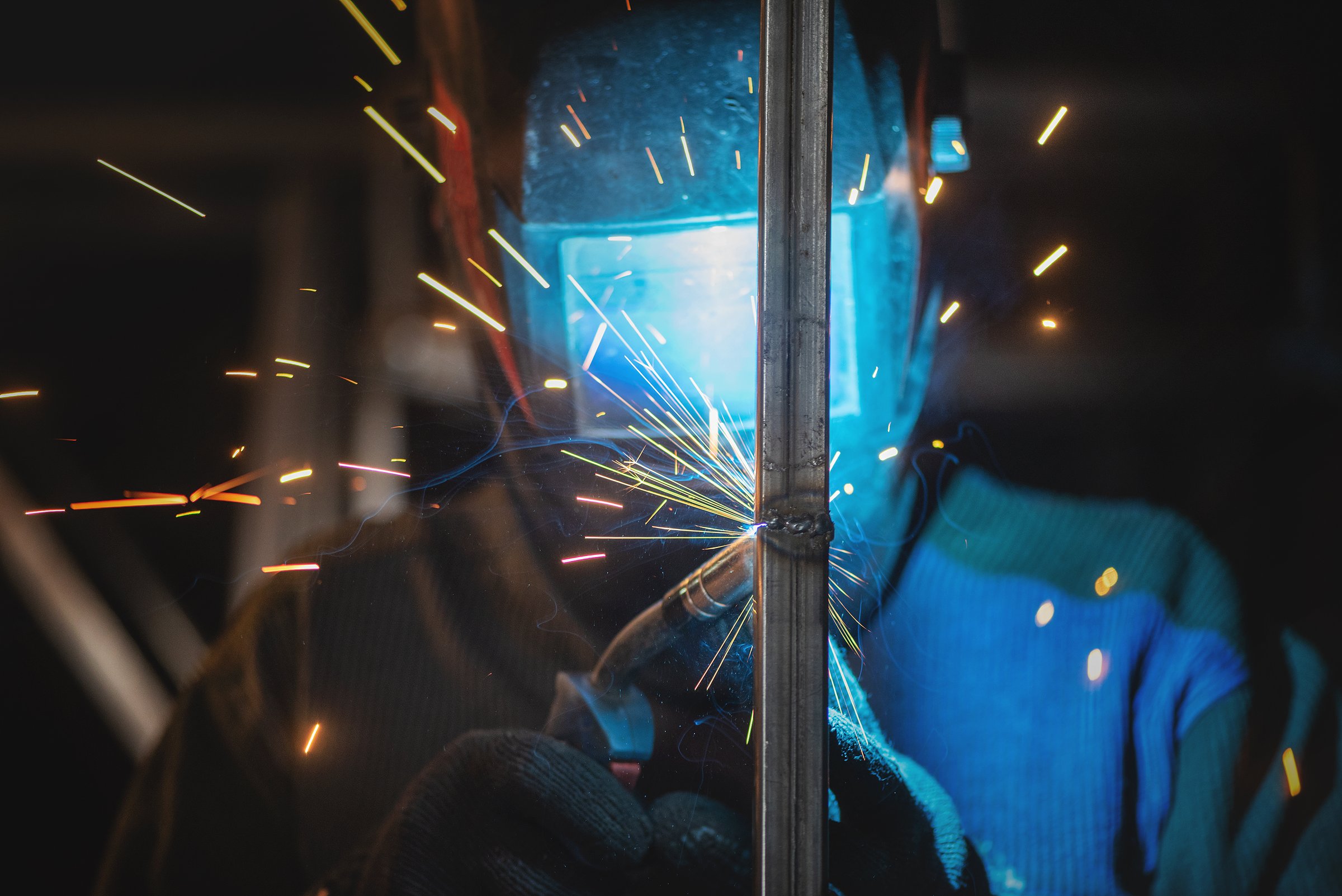 Welder is welding a metal pipes by semi automatic welding