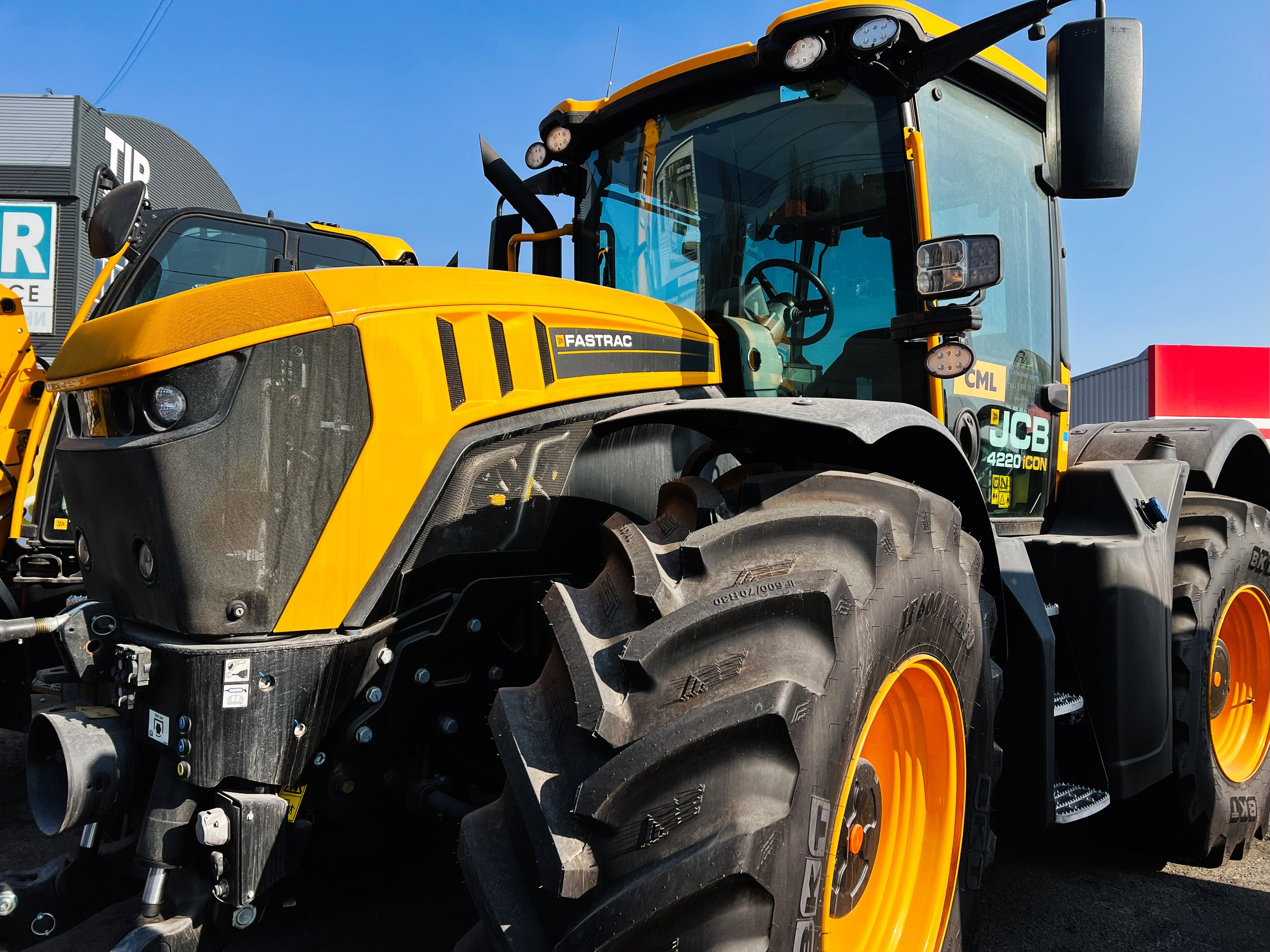 Kyiv, Ukraine - February 26, 2025: Large agricultural JCB tractor on exhibit, showcasing modern farming technology at an equipment event.