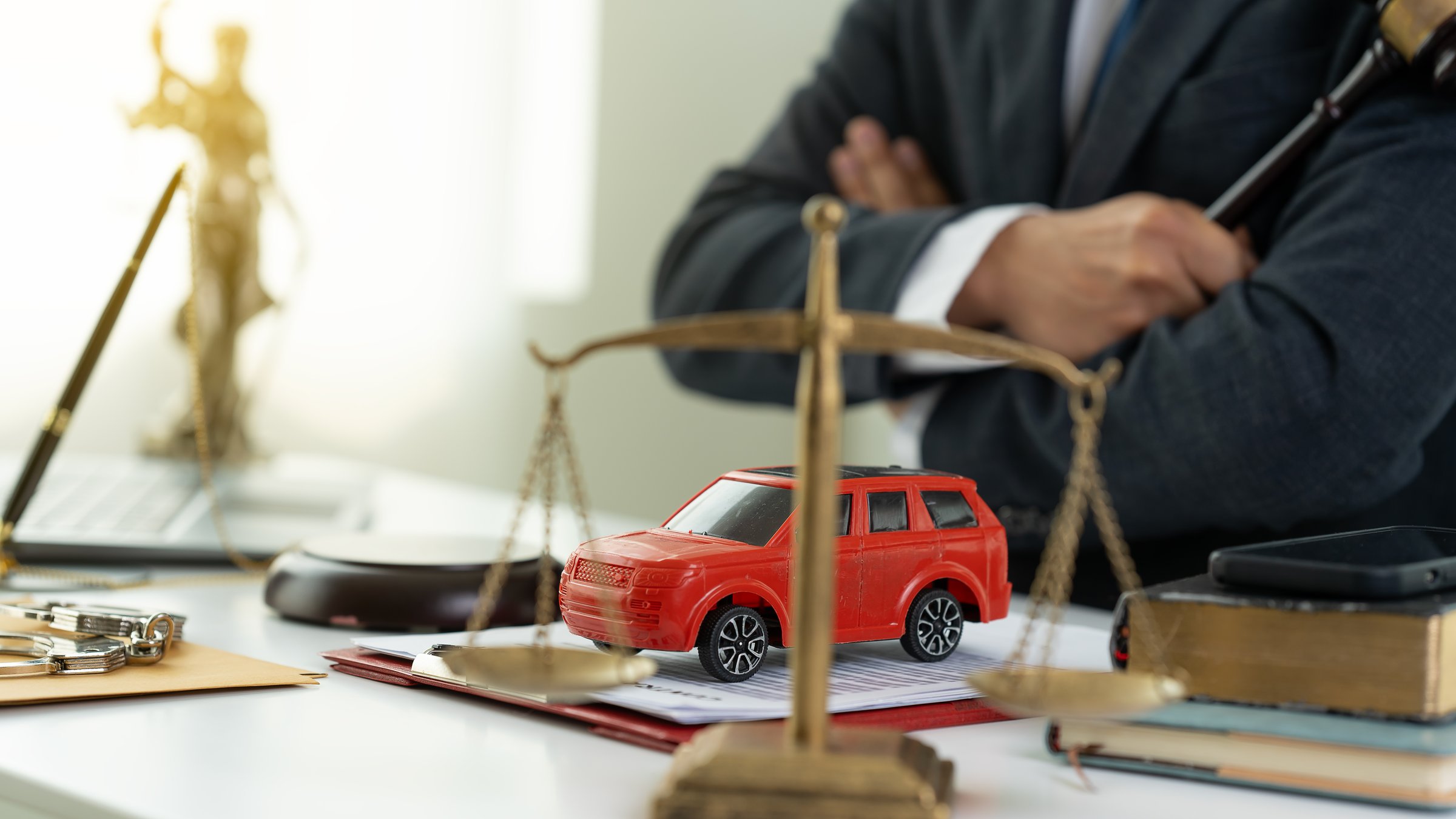 Insurance for court claims in the courtroom Gavels and small toy car models Two cars on the table in the court Lawyer service concept trial Close-up pictures