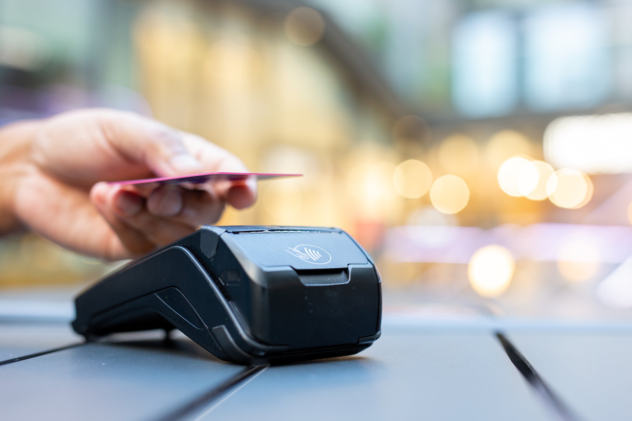 Man Using Credit Card at Checkout