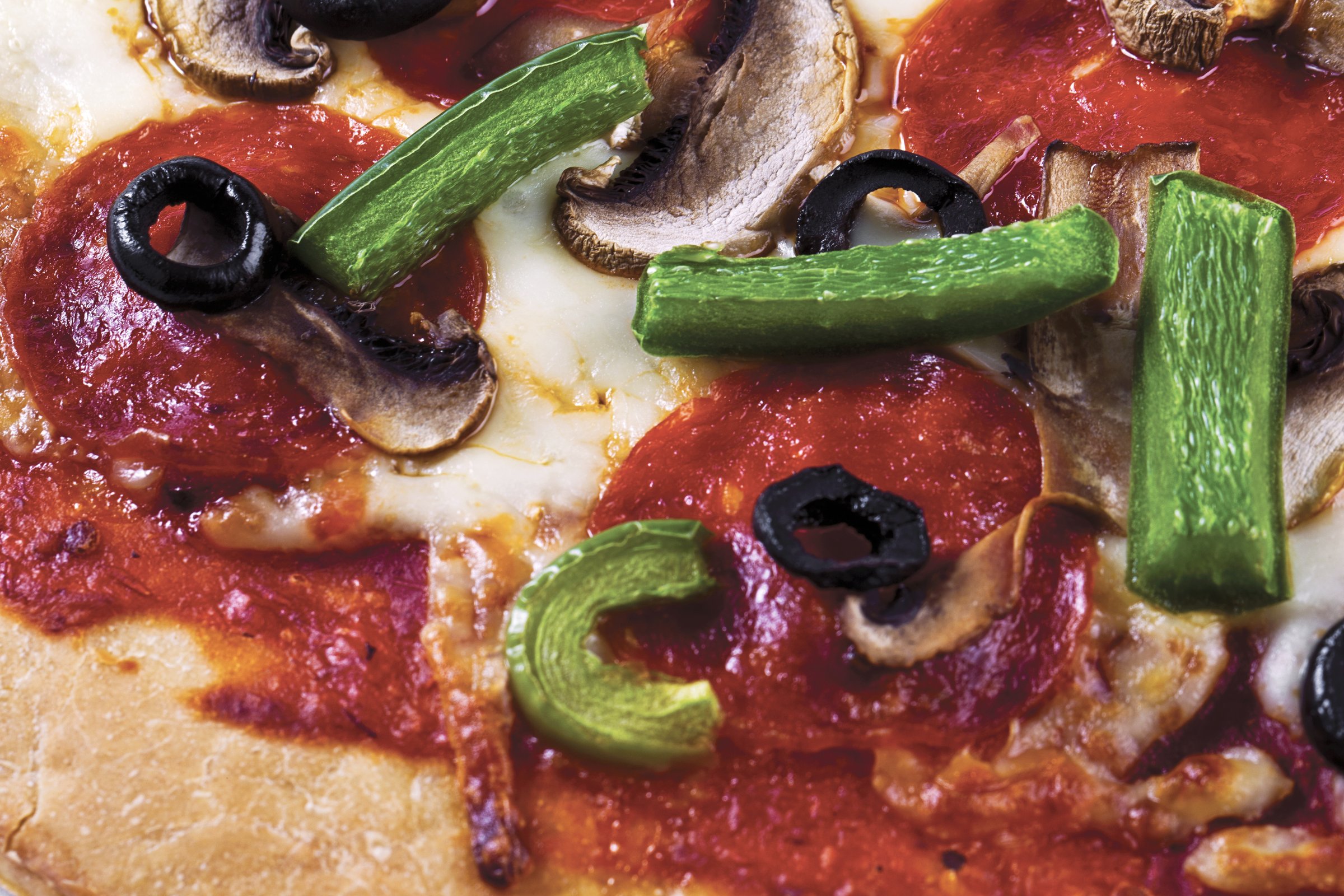 Pizza with mushrooms, tuna, salami, green pepper, onion, and avocado