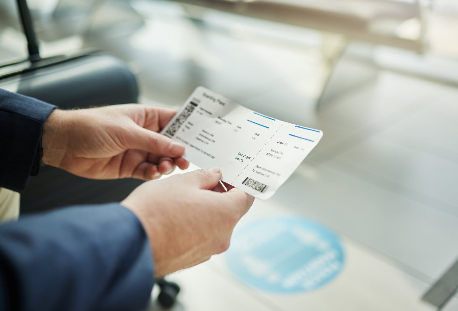 Plane ticket in hands, travel and person at airport, waiting on flight for business trip, check in and boarding. Closeup, 
professional conference or convention with travelling for work and journey