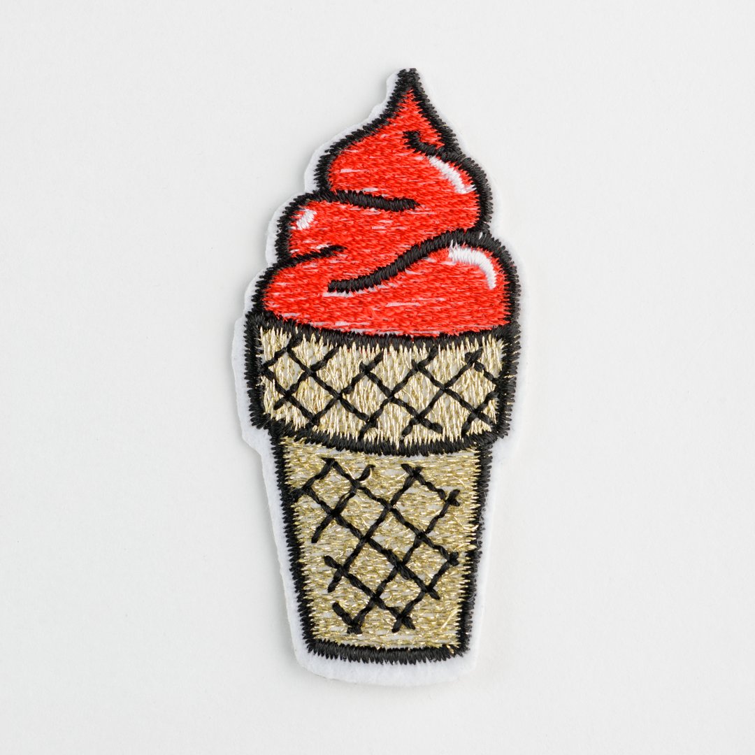 Red ice cream embroidered patch on white background. Fix or style up your clothing.