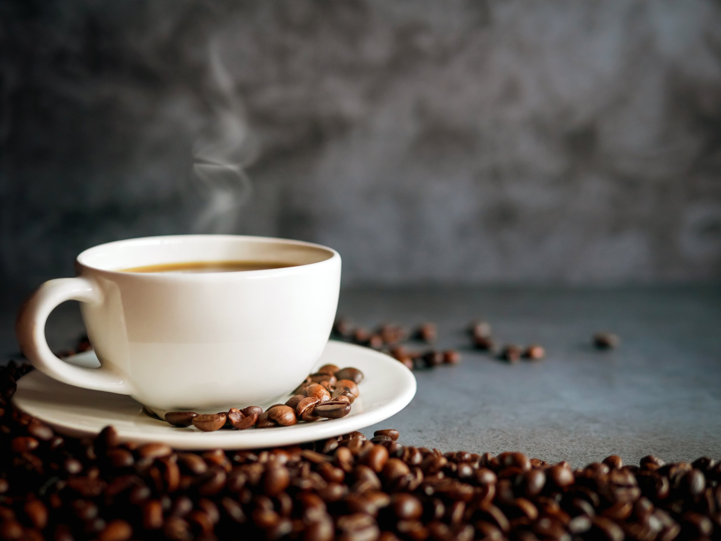 Coffee cup and coffee beans on  gray background, Black coffee cup aromatic