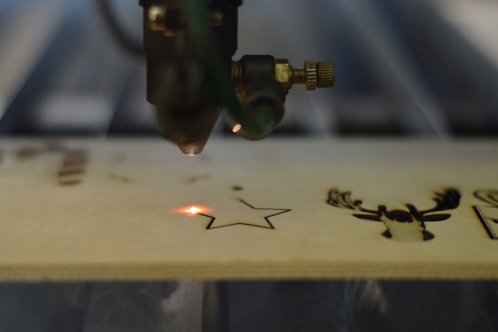 Laser cutting machine cutting plywood christmas decoration.