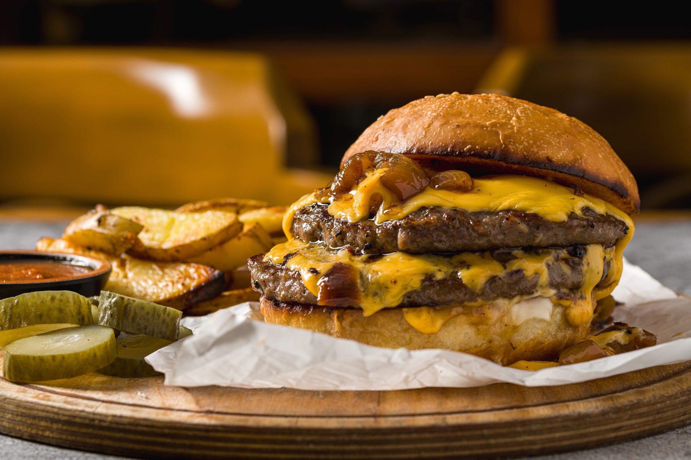 Smash burger with cheddar cheese and caramelized onions, served with fries