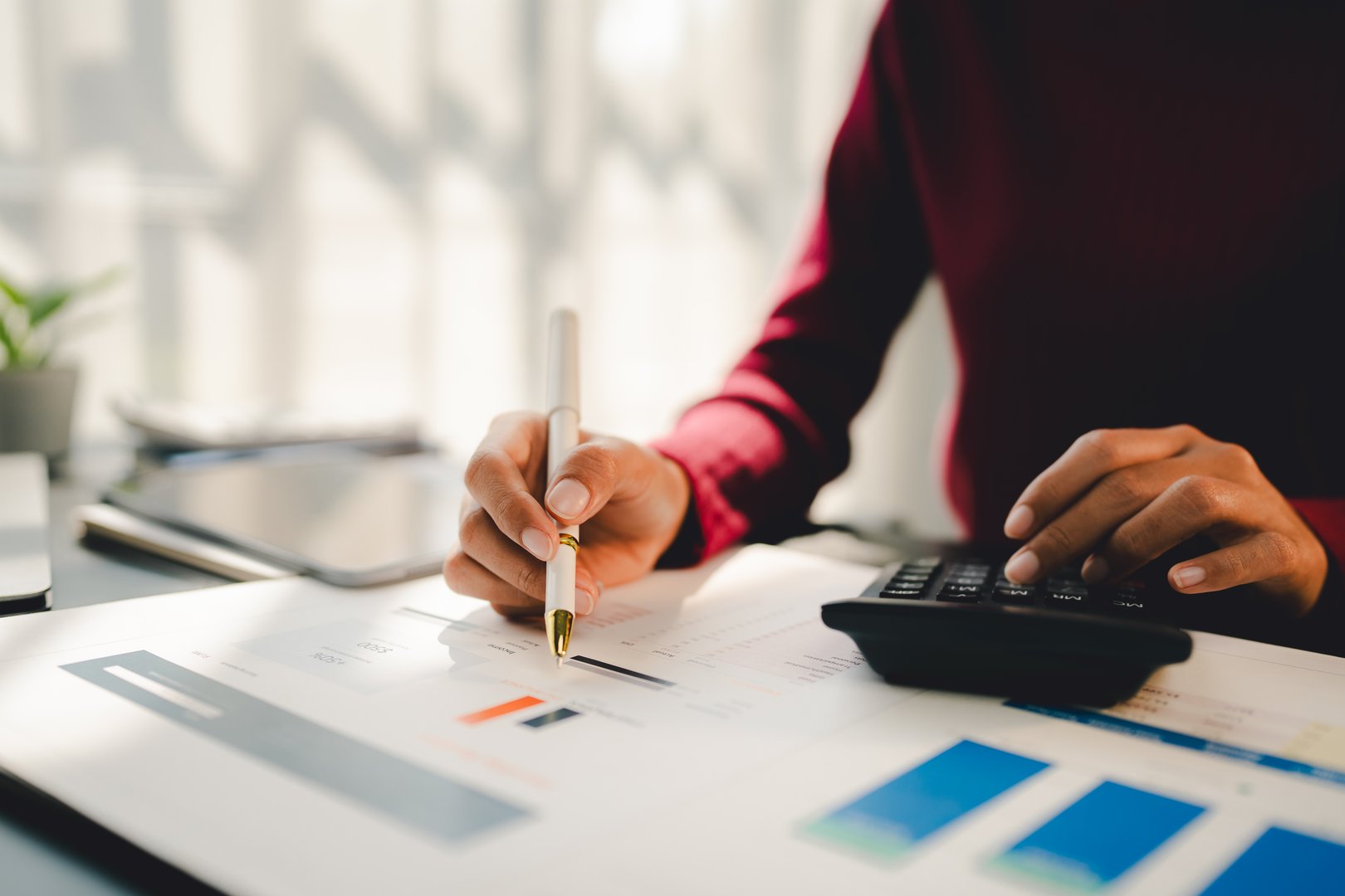 Portrait of a woman working on a tablet computer in a modern office. Make an account analysis report. real estate investment information financial and tax system concepts