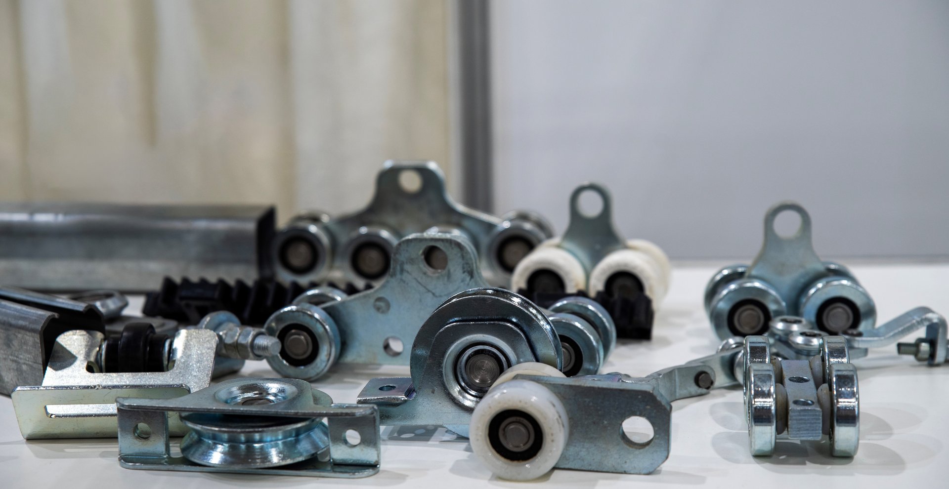 Metal roller brackets and pulleys for sliding gates