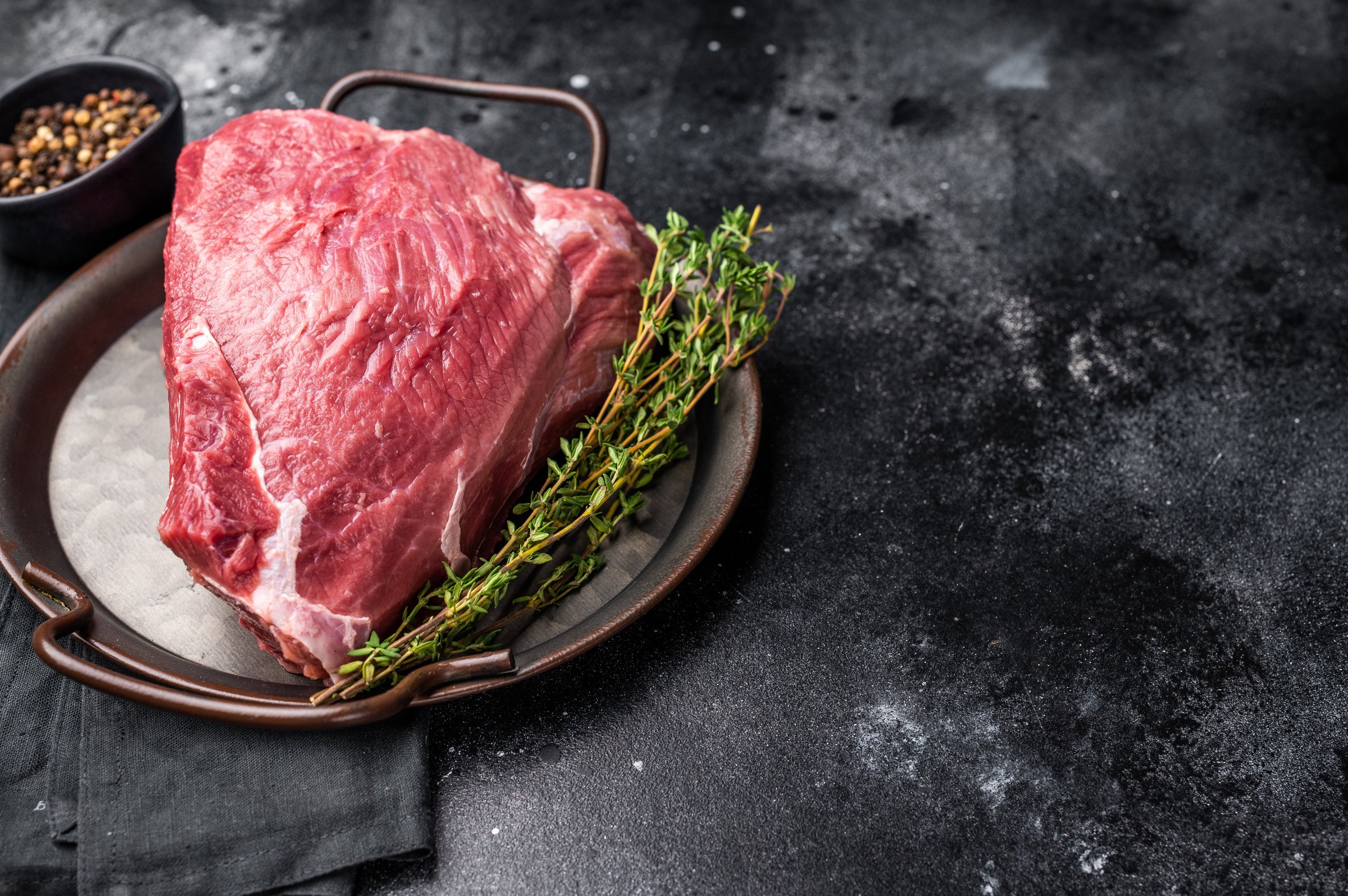 Raw Wild Boar meat, fresh Game Meat. black background. top view.