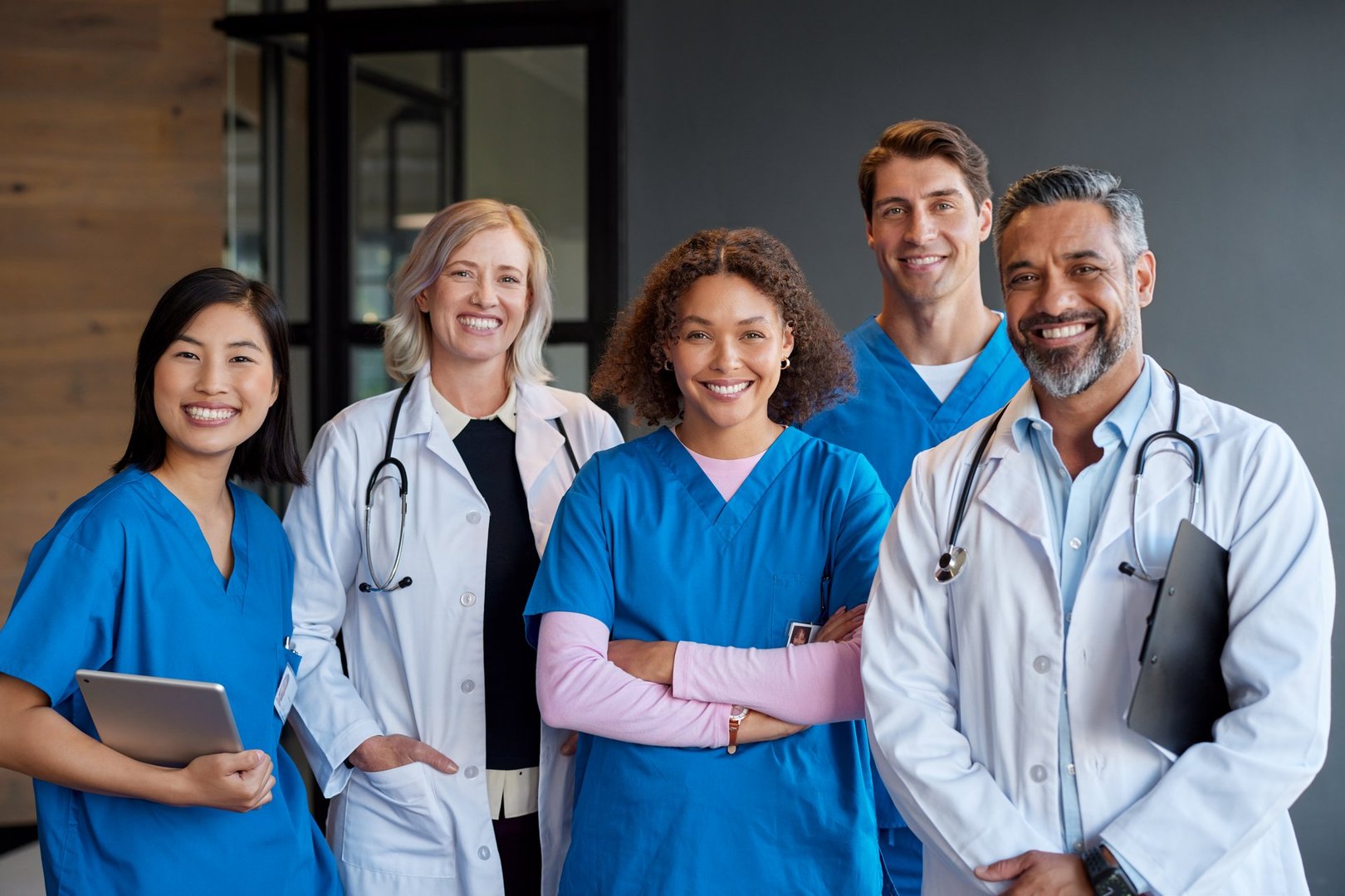 Multiethnic group of healthcare professionals smiling and looking at camera. Doctors and nurses posing as a united medical team. Portrait of friendly and successful medical staff showcasing teamwork and professionalism.