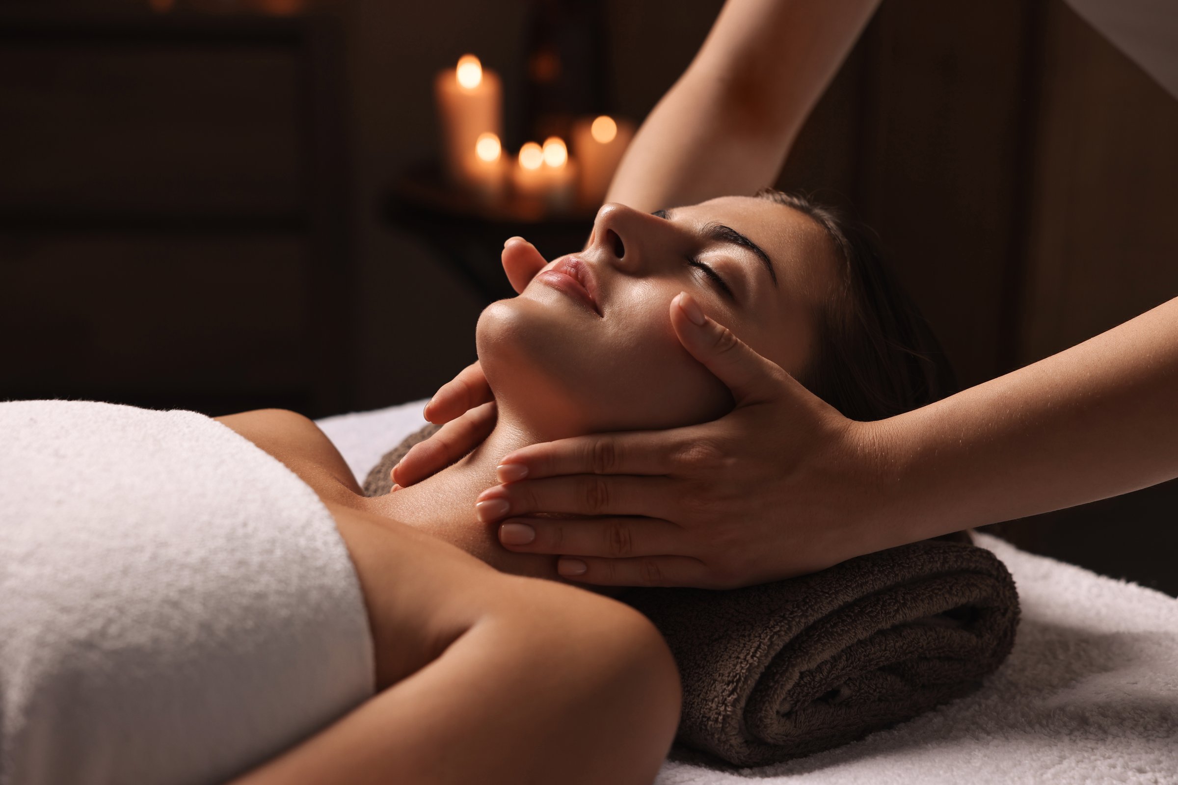 Attractive woman enjoying face massage, closeup. Beauty procedure