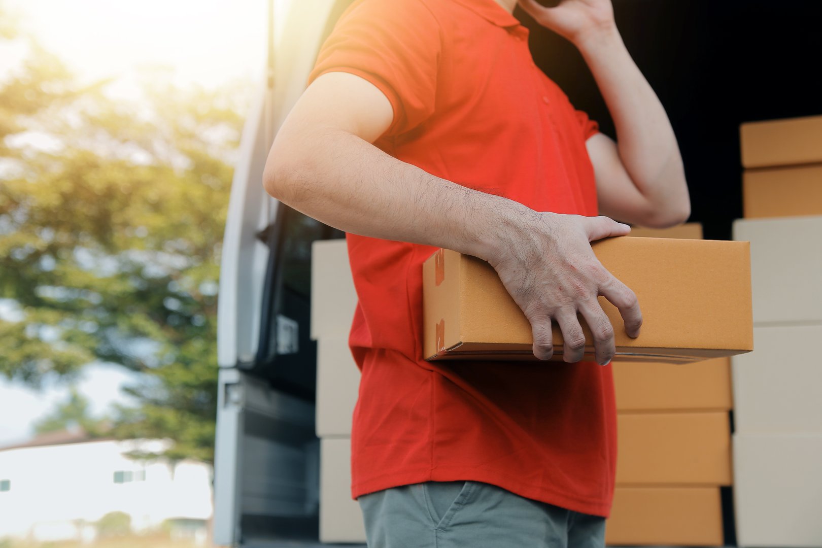 Asian delivery express courier young man use giving boxes to woman customer he wearing protective face mask at front home