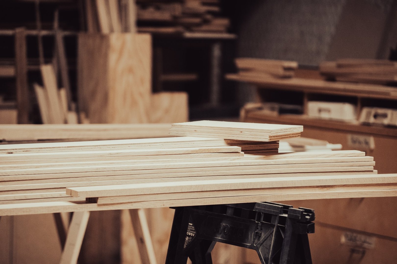 Wood workshop filled with lumbar and supplies.