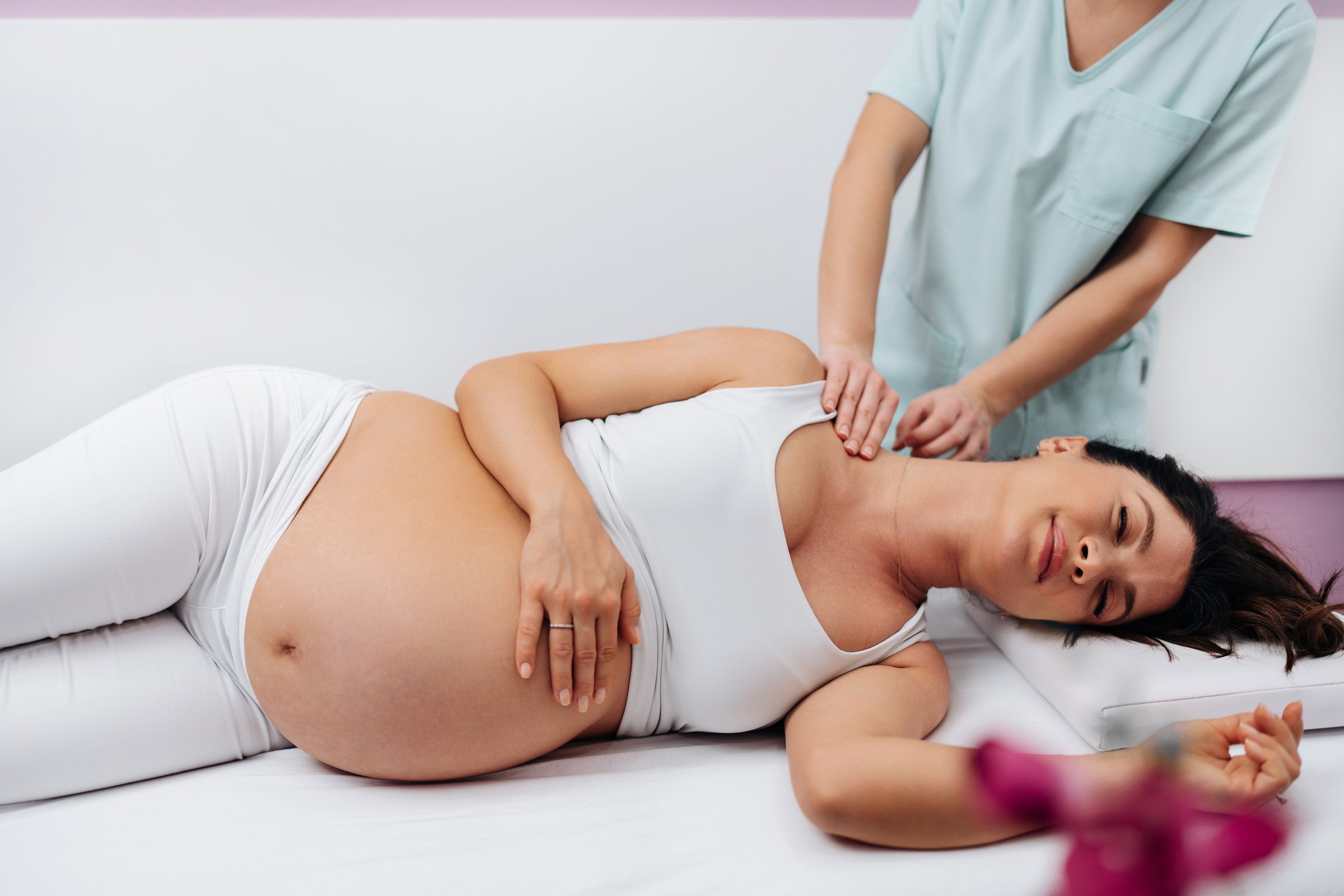 Beautiful pregnant woman relaxing during prenatal massage at Divina Skin and Body in Sarasota