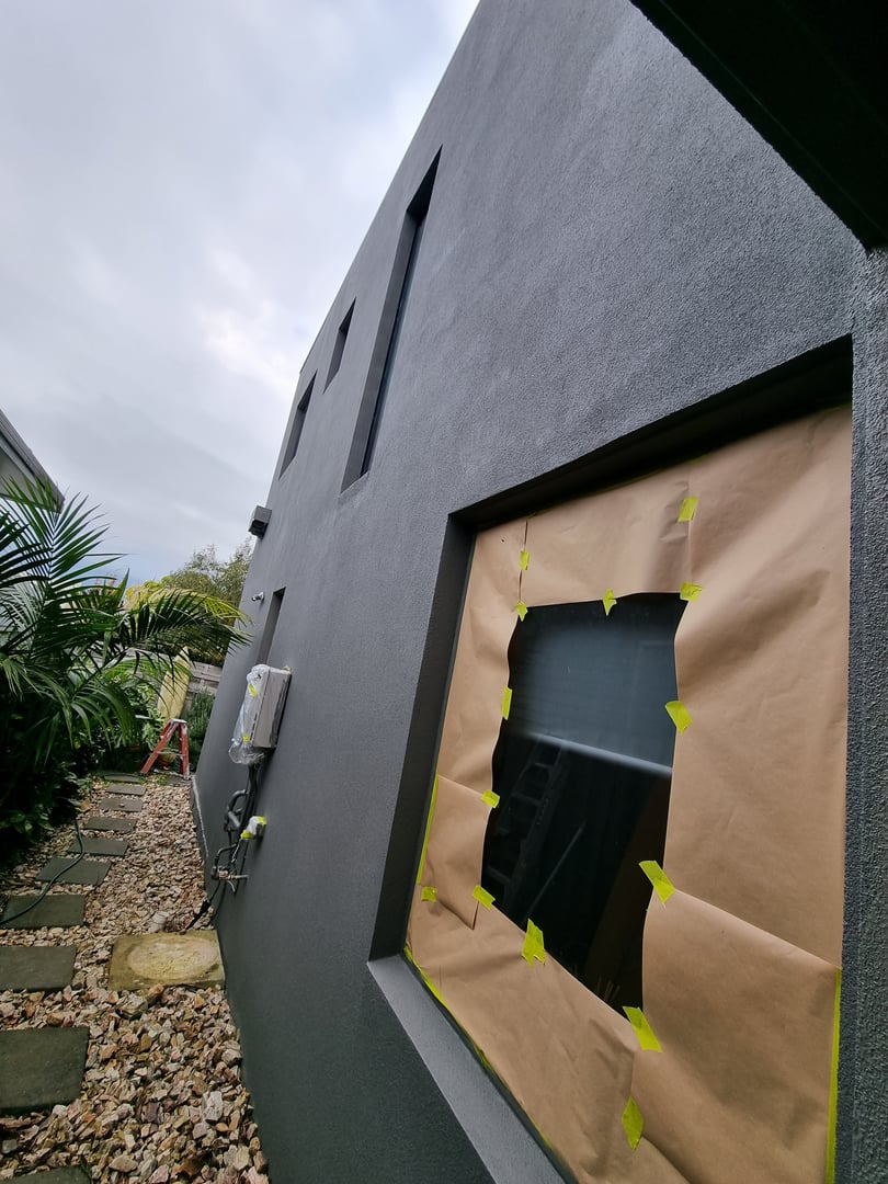 Rendered cladding restoration showing protective coating application