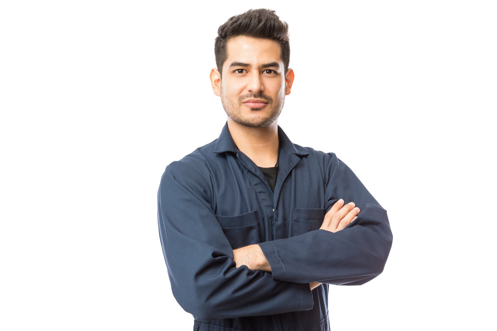 Confident young male mechanic standing arms crossed against white background