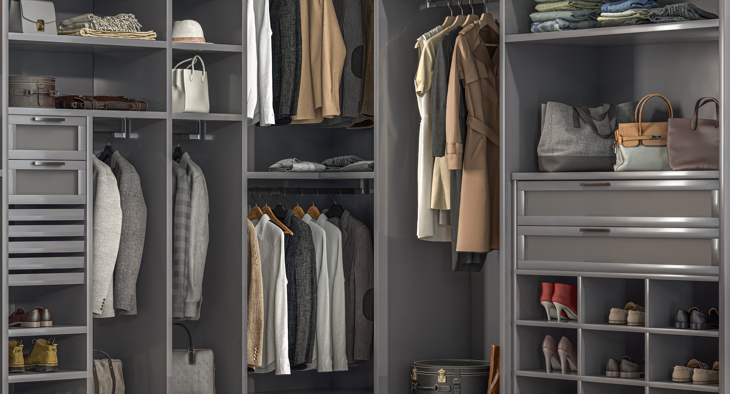 Large, gray, well-organized walk-in closet showcasing hanging clothes, folded sweaters, shoes, handbags, and accessories