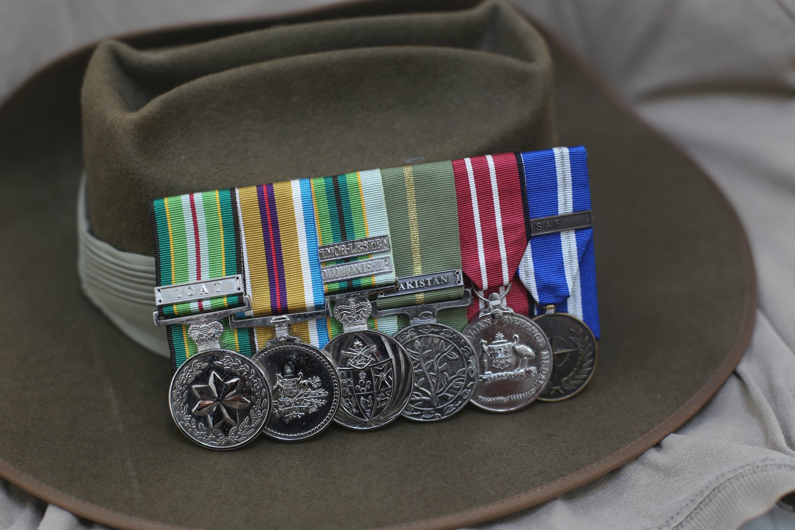 Several service medals leaning against an Australian Army Slouch Hat.