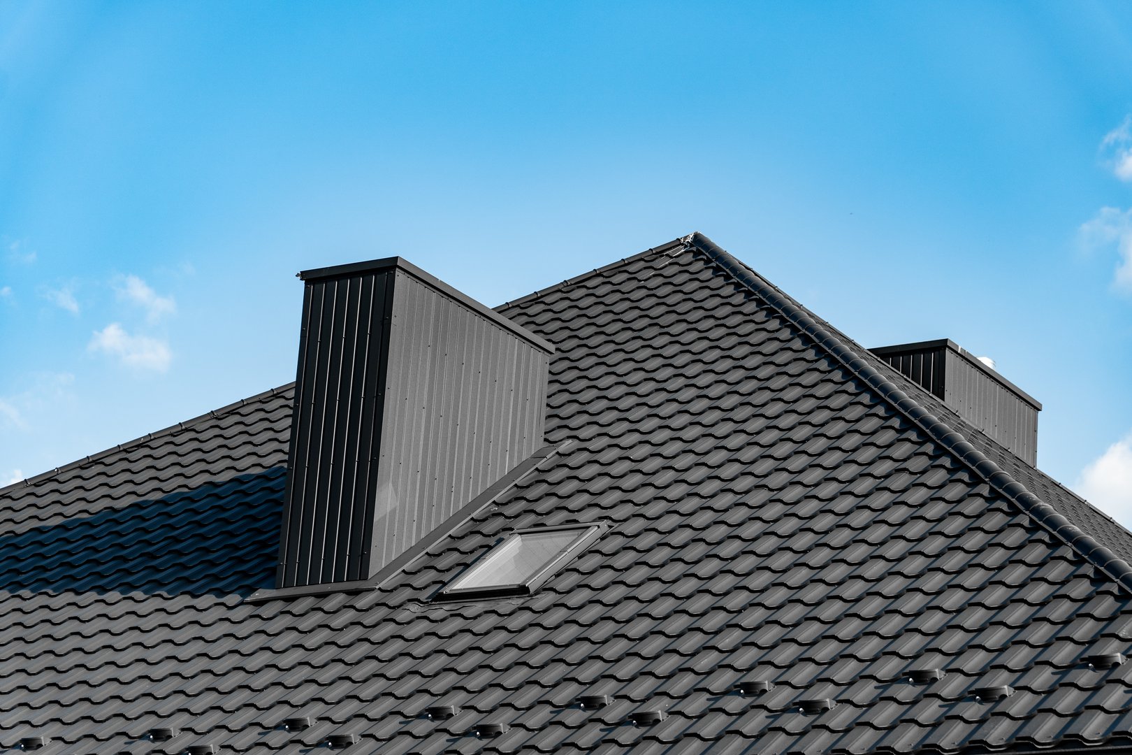 Residential roof replacement Lincoln Nebraska - black architectural shingles with skylights