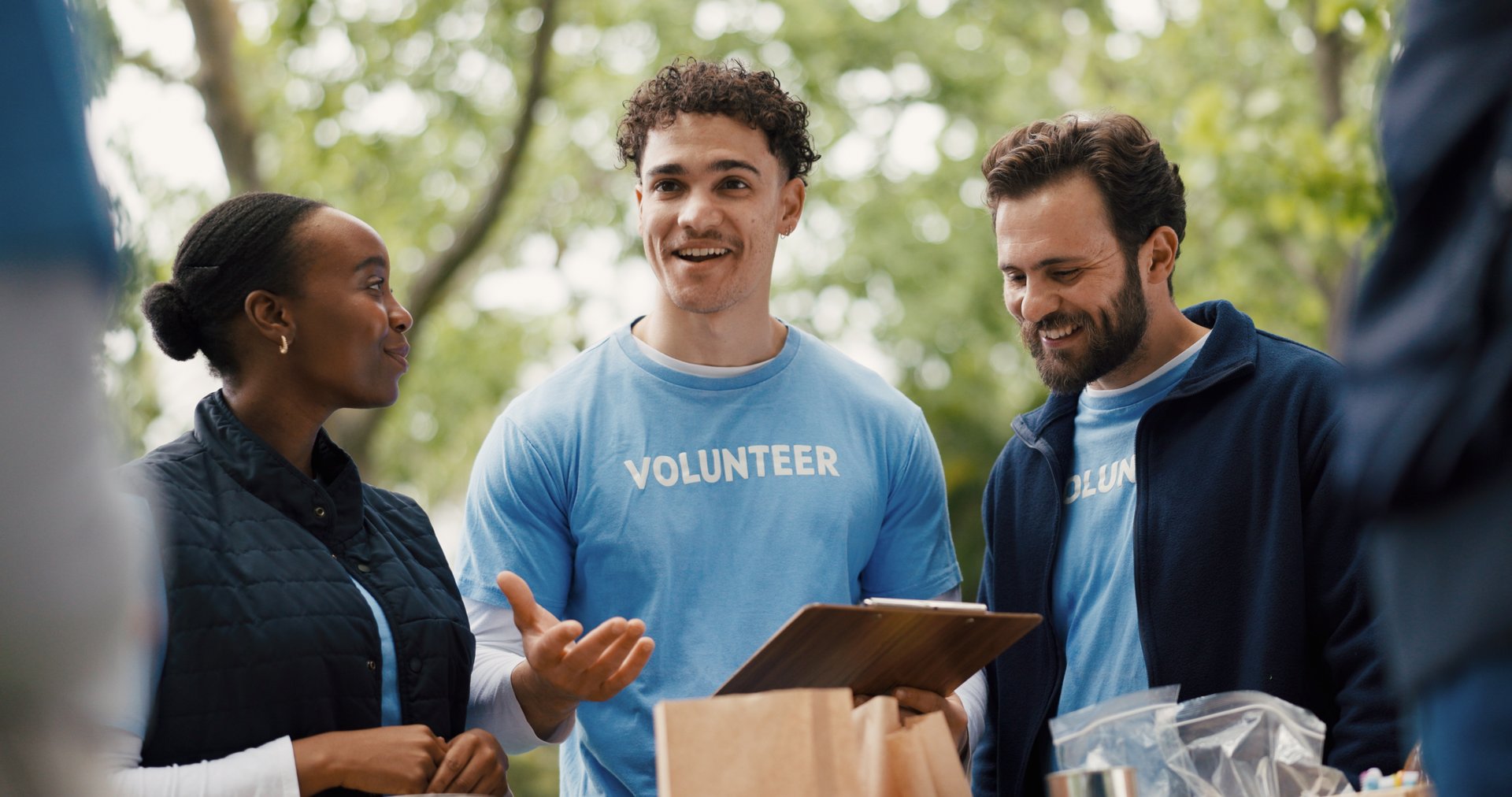 Happy volunteers working together for charity in park