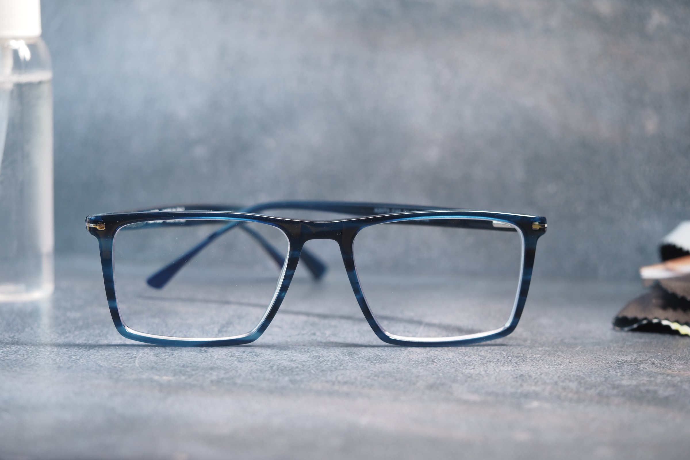 eyewear with spray and cleaning cloths on table .