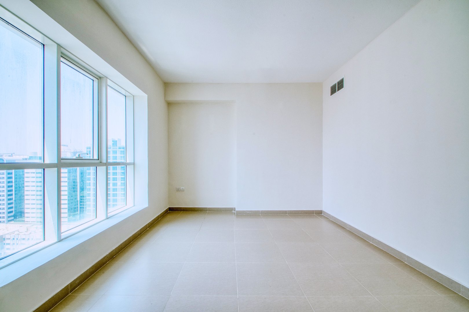 Clean unfurnished apartment interior showcasing spacious layout, raw architectural details, and abundant natural light. Ideal for real estate listings, 3D rendering backgrounds, or minimalist design inspiration.