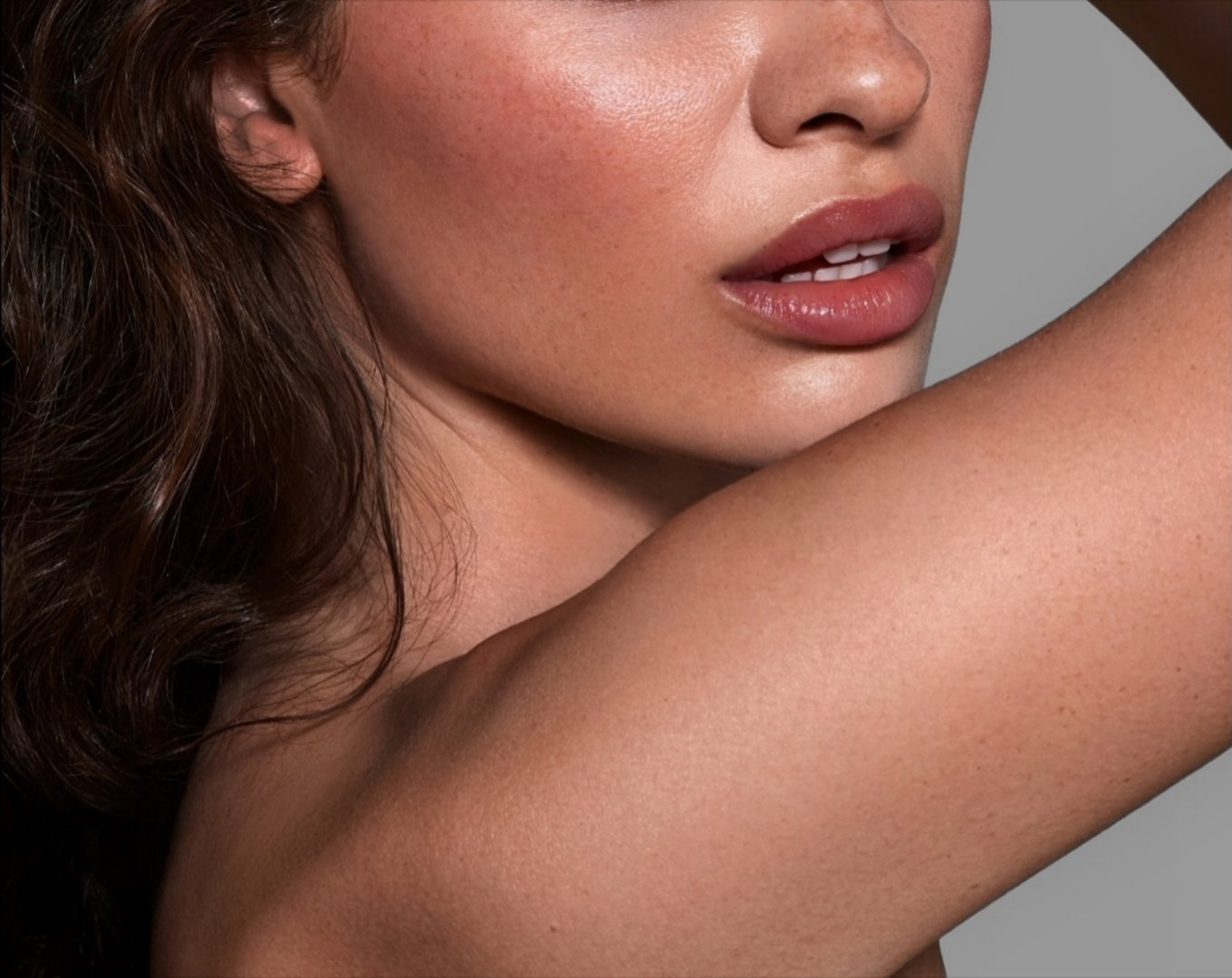 Minimalist close-up of a serene and attractive young woman with natural glowing skin and soft, silky hair. Cropped half-face composition ideal for skincare, beauty, and lifestyle concepts