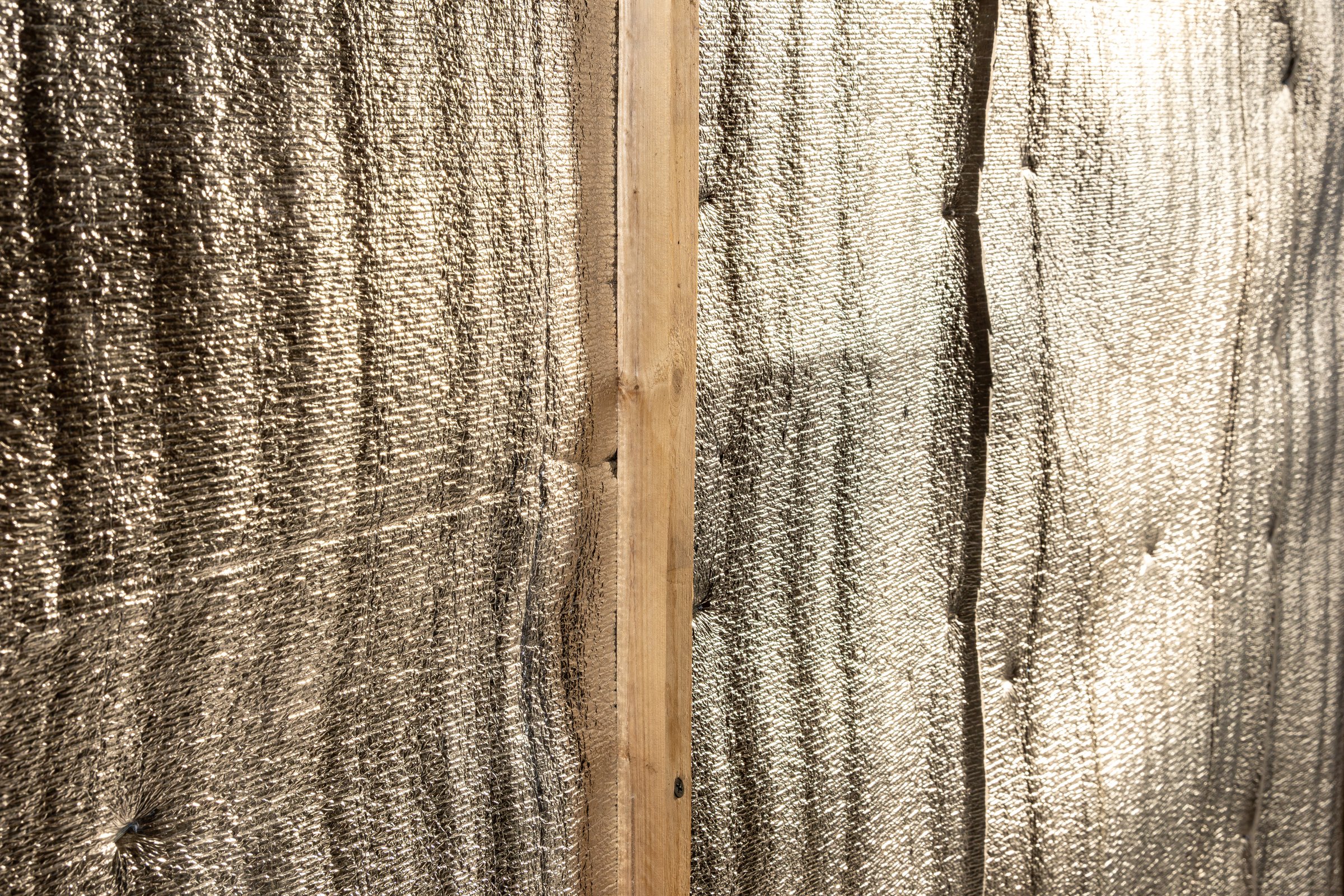 The reflective layer reduces radiant heat transfer