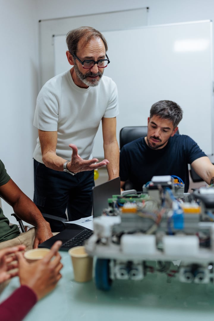 Robotics engineers testing and programming a new prototype of a robot in their office