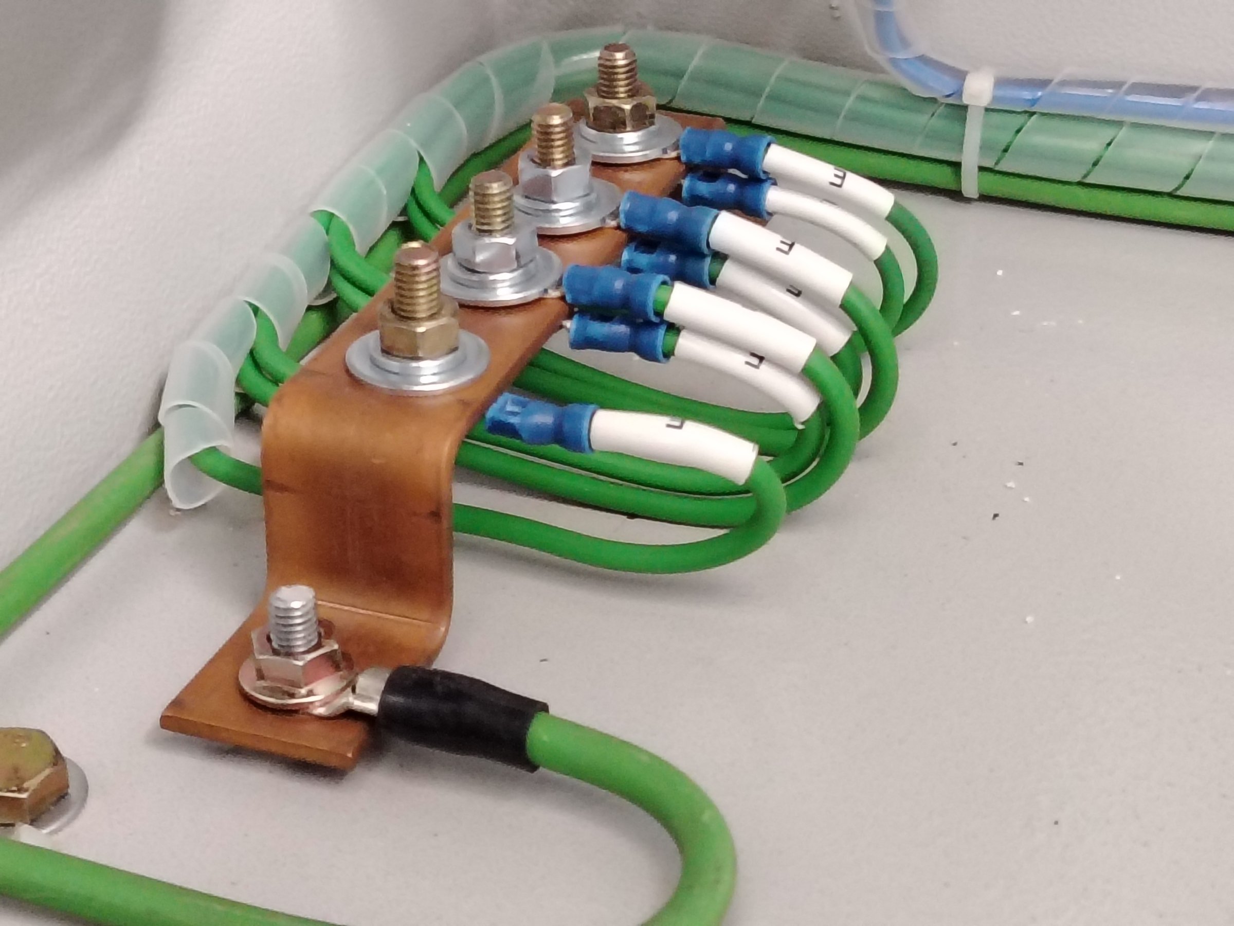 Circuit protection, secure connection of green wires to a grounding bar.