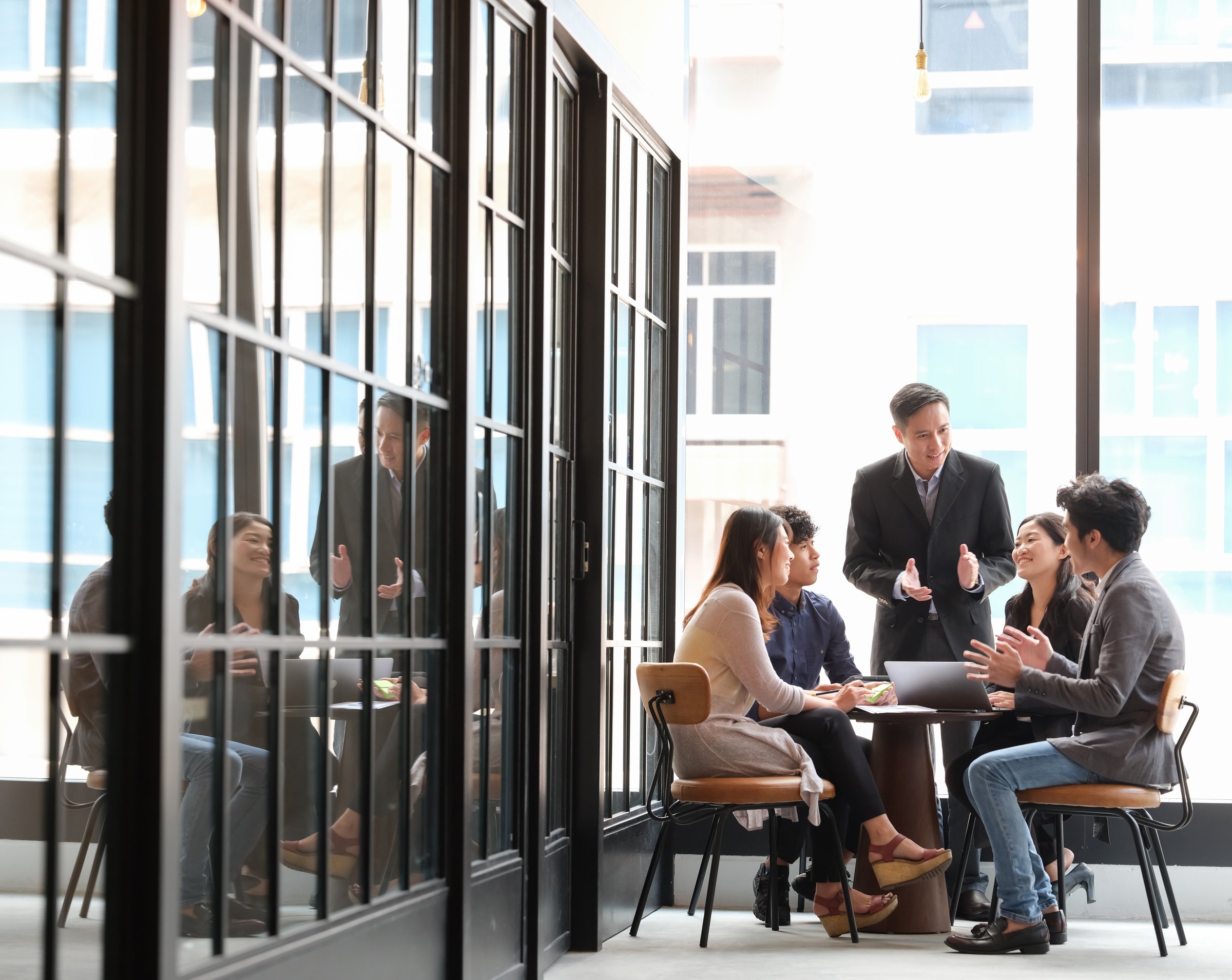 young creatives and team leader in discussion in an open working environment