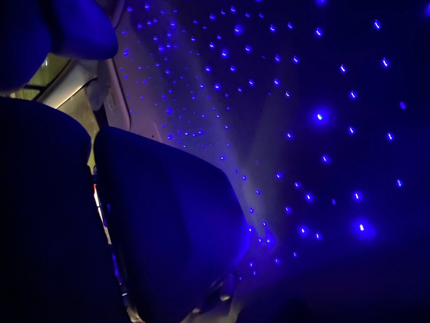 Envision a captivating scene within the confines of a taxi adorned with a cosmic ambiance. The interior is transformed into a magical haven, where the conventional fades away, and the extraordinary takes center stage. Overhead, a simulated night sky twinkles with a myriad of radiant blue stars. These celestial bodies cast a gentle glow, creating an enchanting atmosphere that transcends the ordinary.

The taxi seats, bathed in the soft luminescence, become vessels of comfort traversing a cosmic expanse. The darkened interior is adorned with a touch of magic, as if passengers have stepped into a realm where the boundaries of reality blur. The illusion of a celestial dome above brings a sense of wonder and tranquility, turning a routine ride into a journey through the cosmos.

As passengers settle into the cosmic embrace of the taxi, they find themselves in a space where the ordinary rules of city transport are momentarily suspended. The journey becomes not just a physical commute but a passage through a starlit universe, where the familiar streets of the city coexist with the mysteries of the night sky. It's an experience that elevates the ordinary to the extraordinary, making even the briefest taxi ride a memorable and magical interlude.