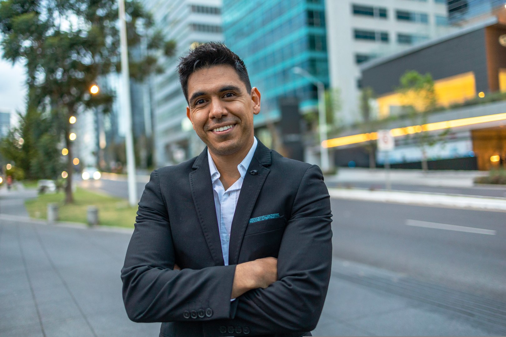 A portrait of a young Mexican smiling, happy, successful business man.Looking at the camera