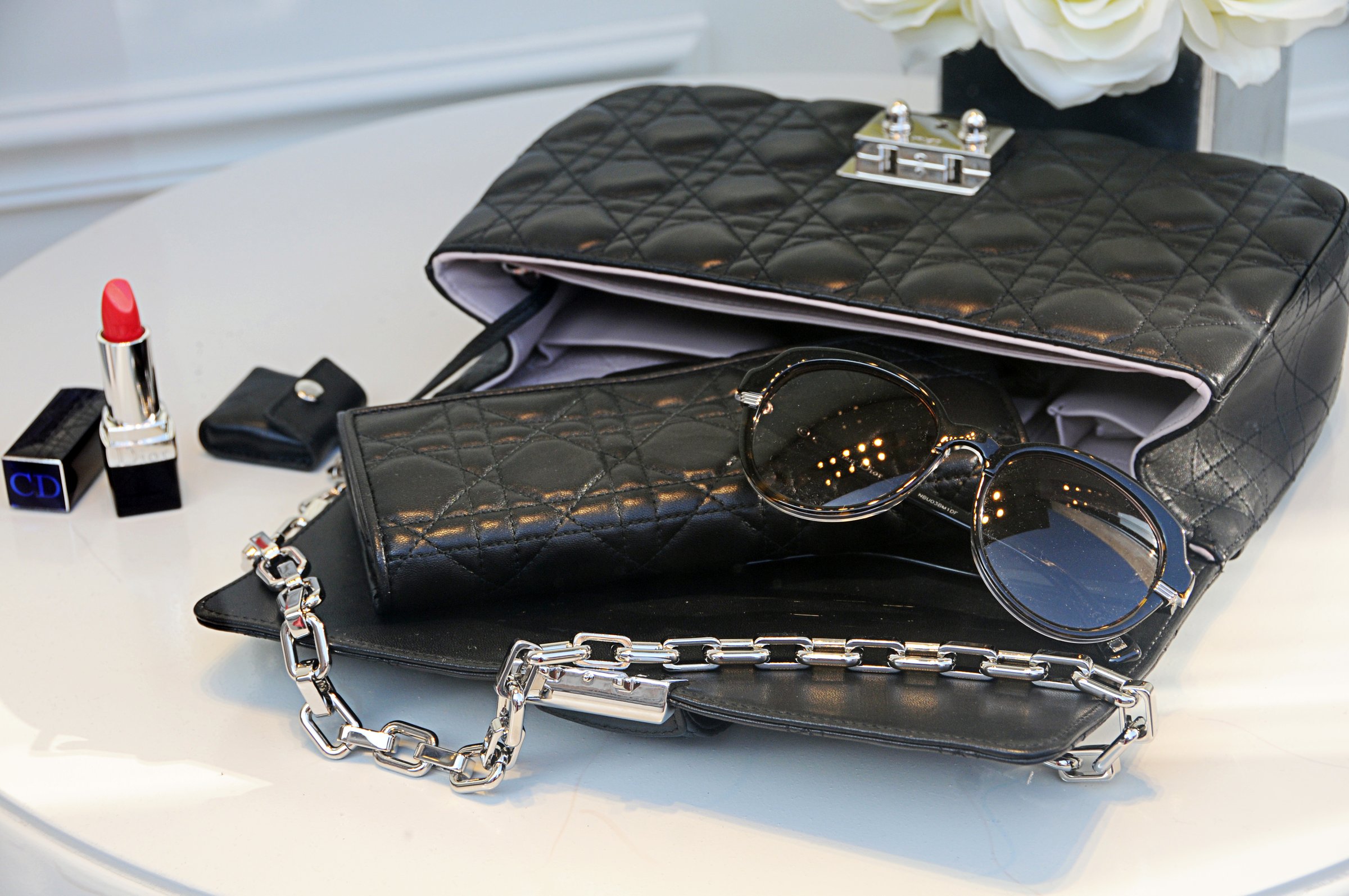 Rome ,Italy - March, 5 ,2012 : Christian Dior shop window with display of Christian Dior Accessories : Bag, sunglasses,red lipstick