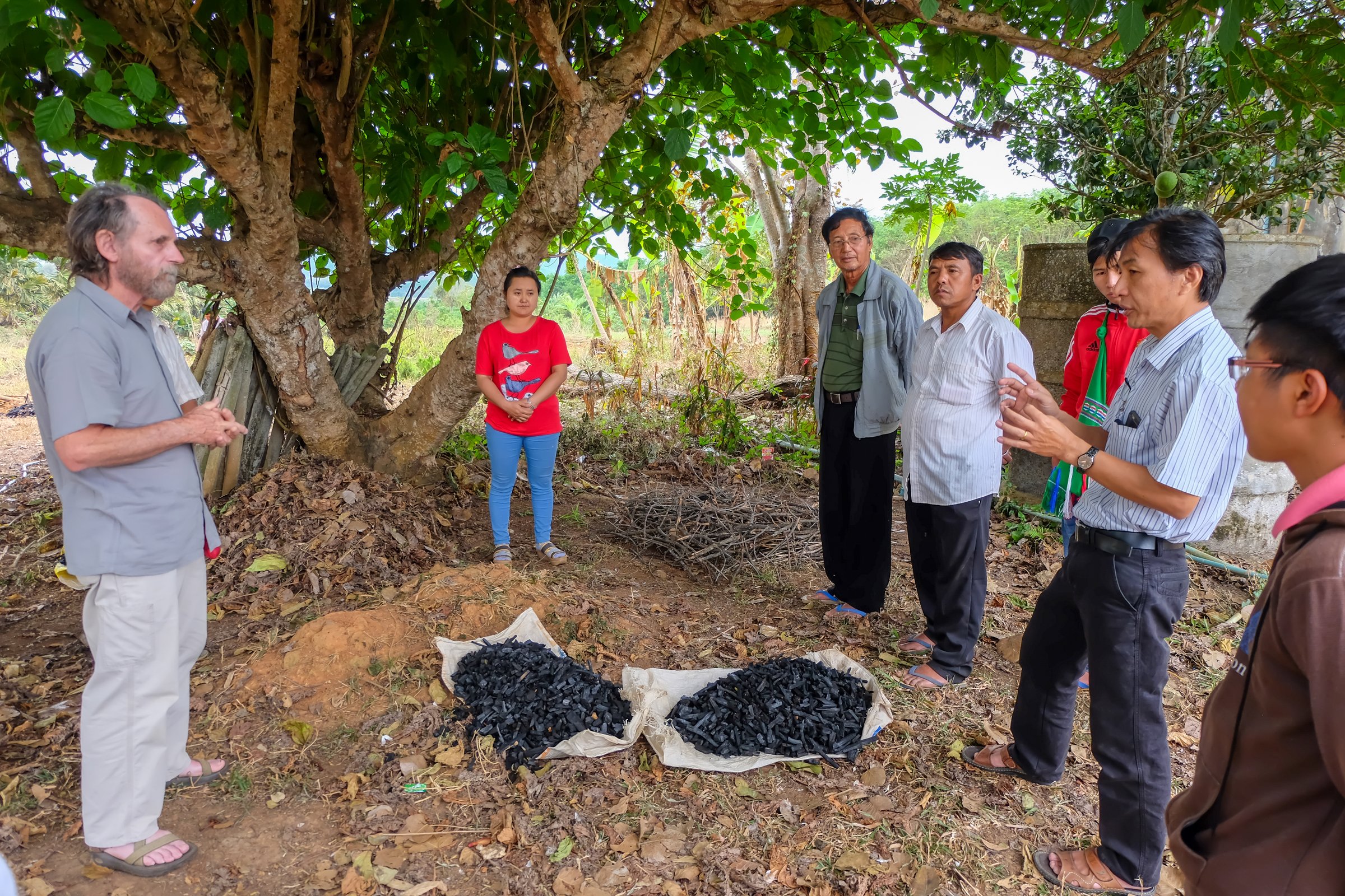 Tachileik, Myanmar - April 1 2017. Teacher (left) and translator (right) at workshop on renewable energy explaining the benefits of using biochar to improve crop yield