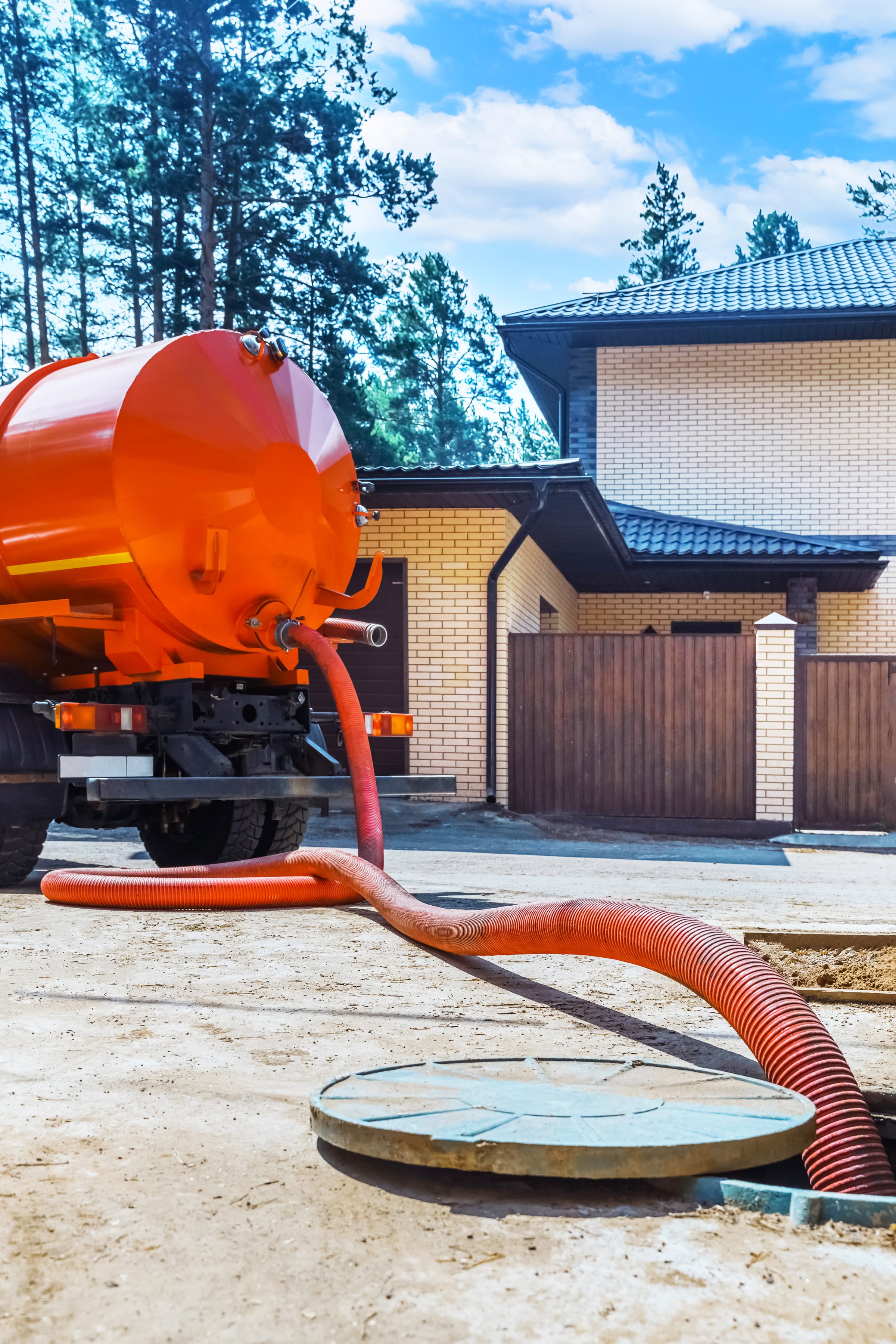 Sewage Tank truck. Sewer pumping machine. Septic truck. Pipe in the drainage pit. Pumping out sewage from a septic tank. Septic tank service