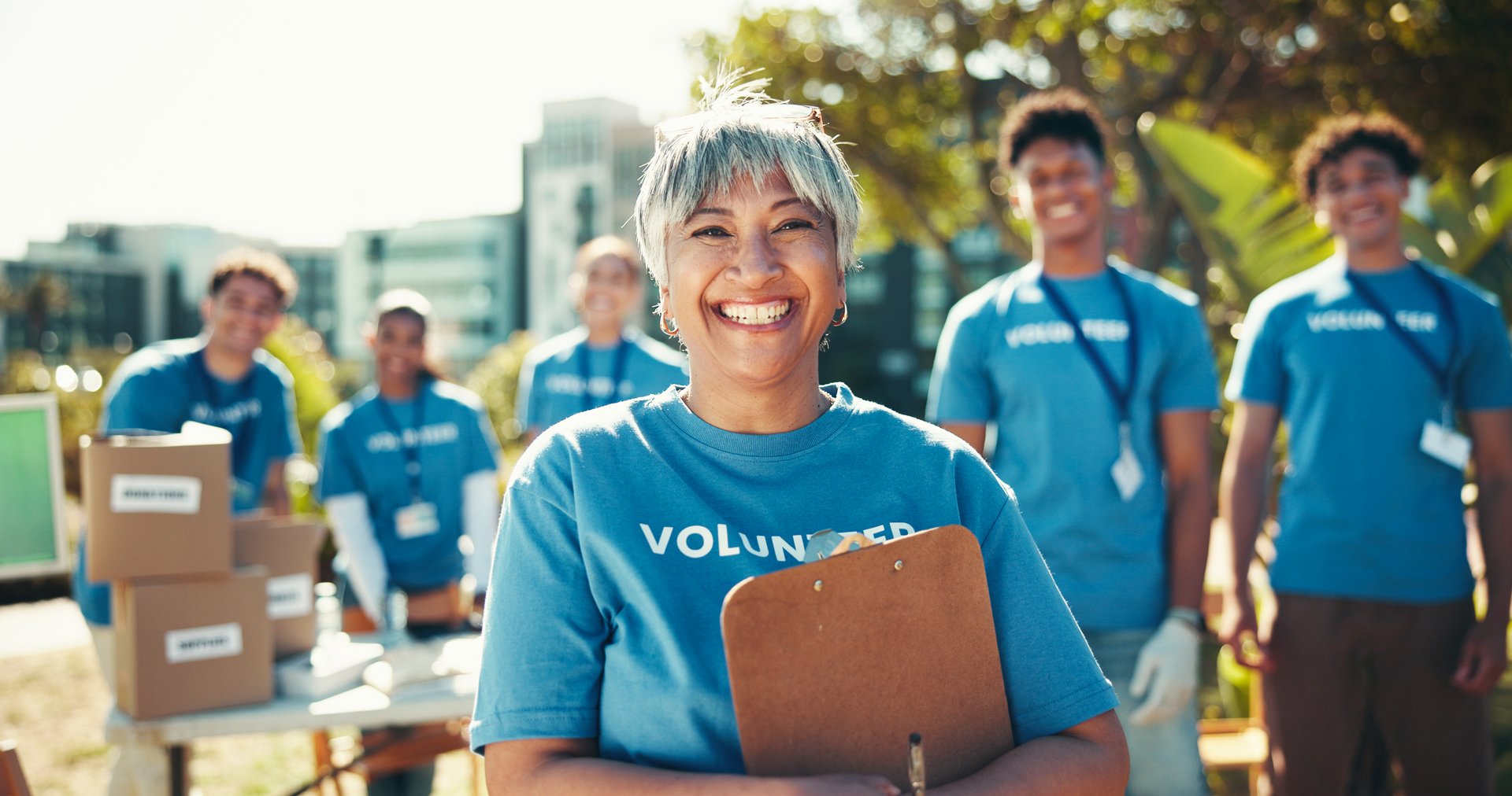 Activism, portrait and smile of woman volunteer outdoor in park for community food drive or donation. Charity, help and society with happy mature person as welfare worker for NGO or non profit