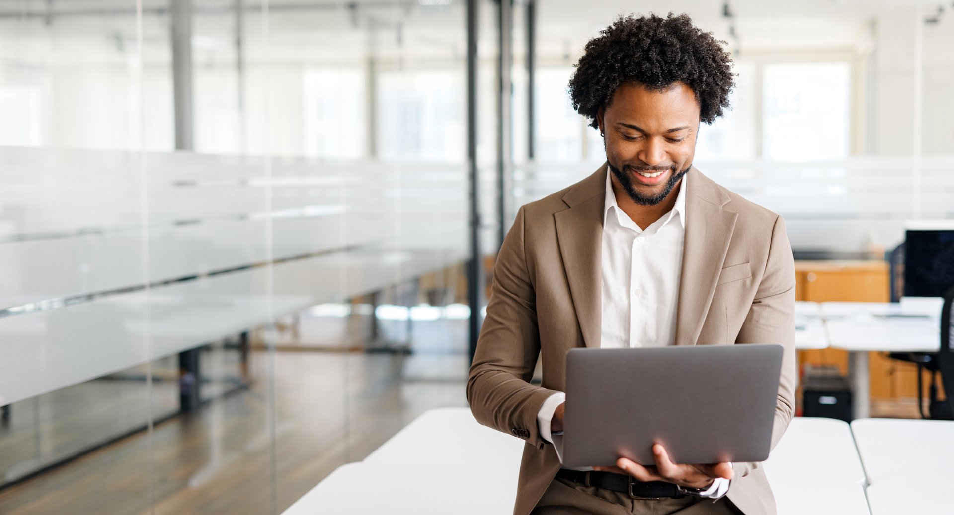 A business professional works intently on a laptop, exuding focus and dedication in an office setting. Concept of business analytics, focused work ethic, and digital business management.