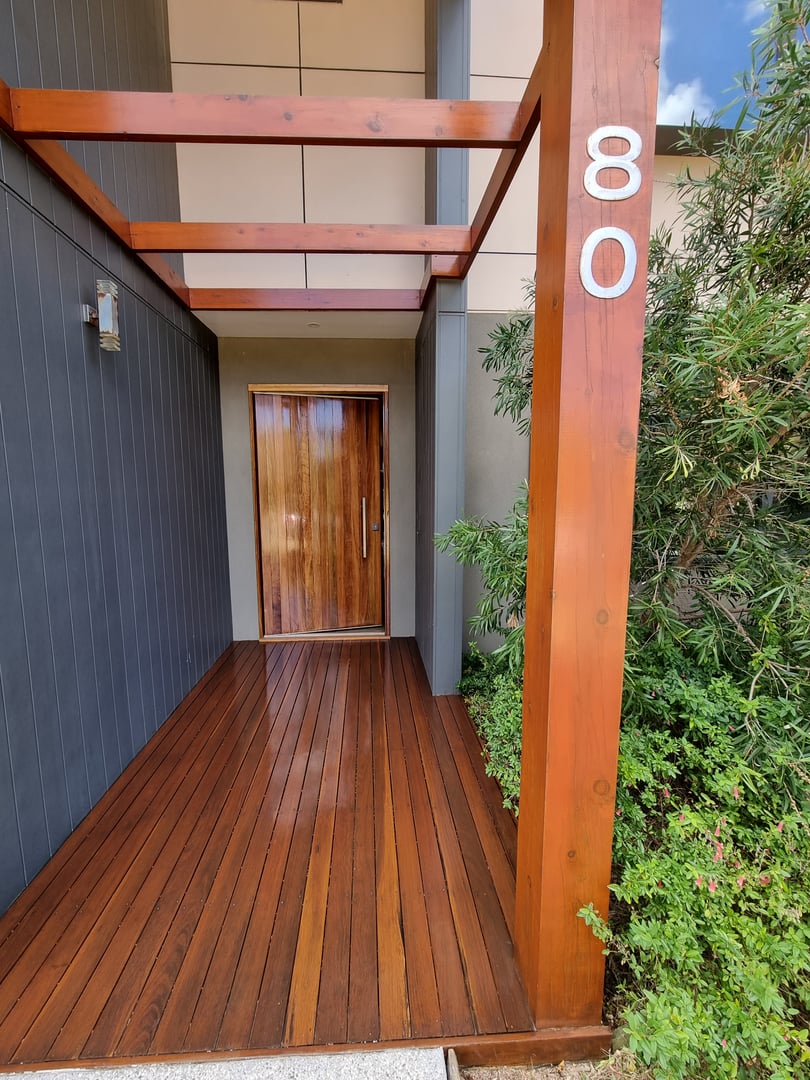 Quality Painting Group deck refinishing project from February 2024 showing professional hardwood deck preparation and staining