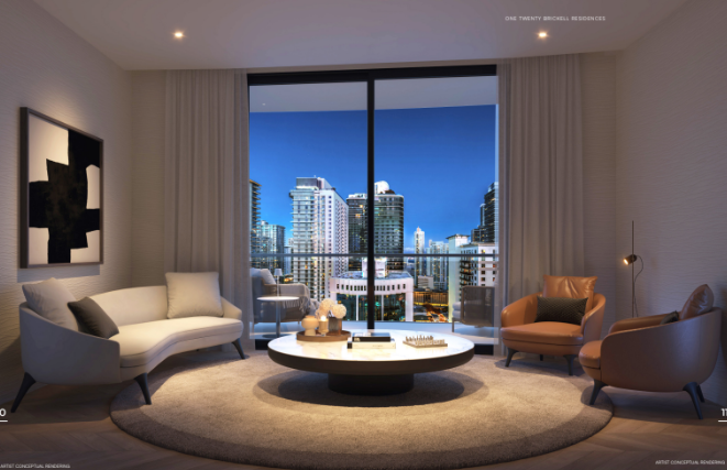 Modern living room with city view, featuring a round coffee table, sofa, armchairs, and large window overlooking skyscrapers.