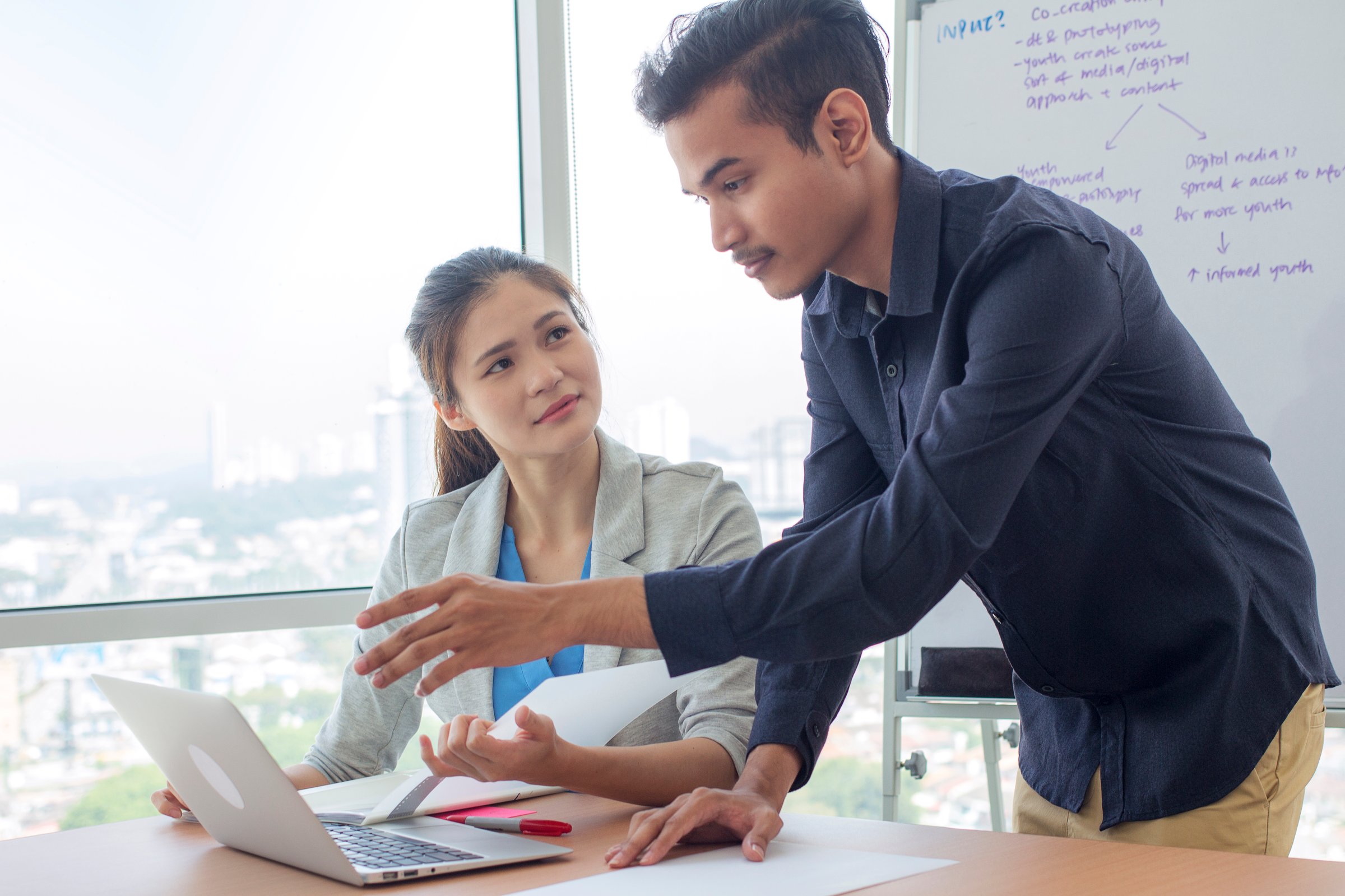 multiracial group of man and woman gather in a meeting room, discussing business plan together.
university student presenting and explaining homeworks to the lecturer