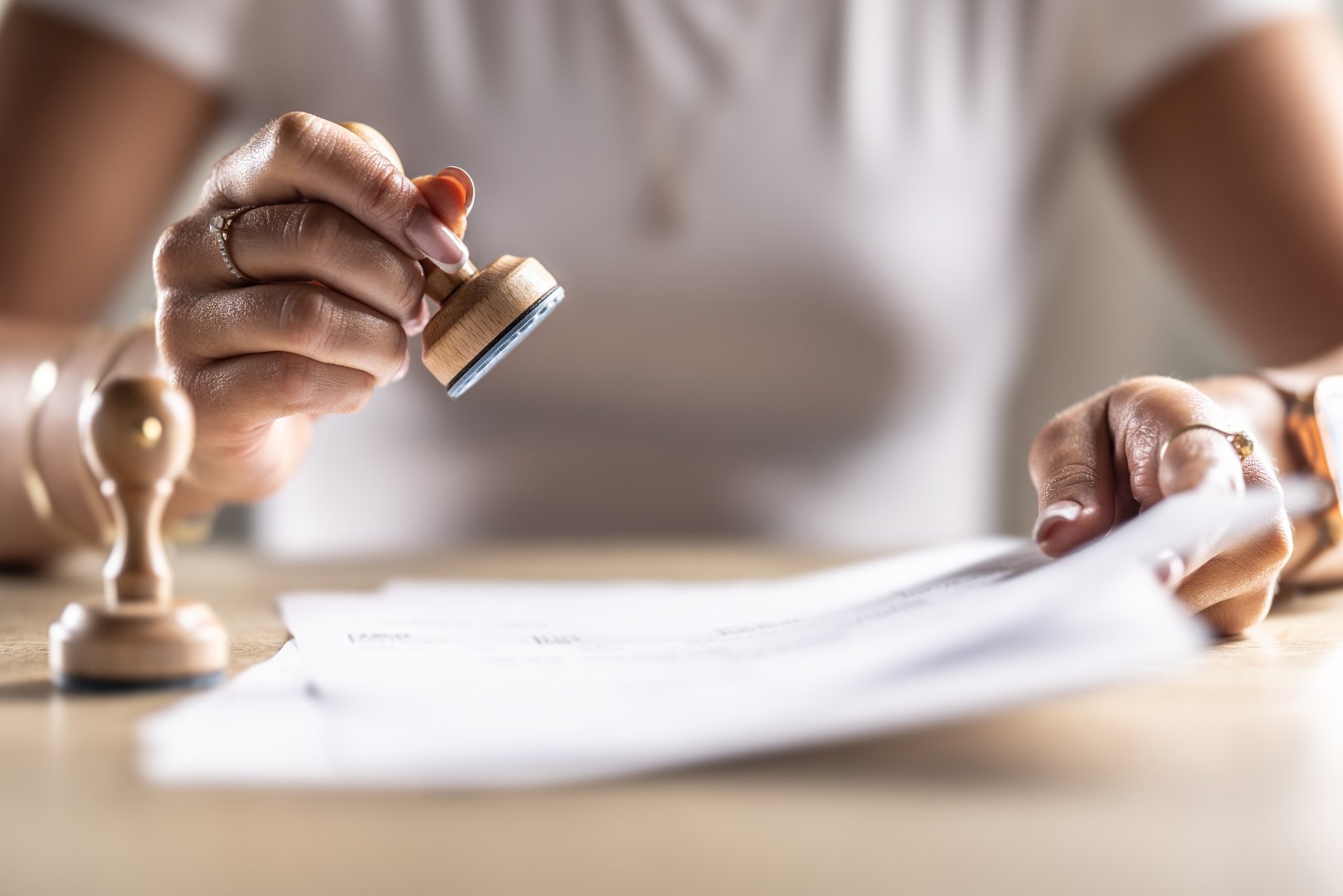 The notary office assistant stamps the archived document