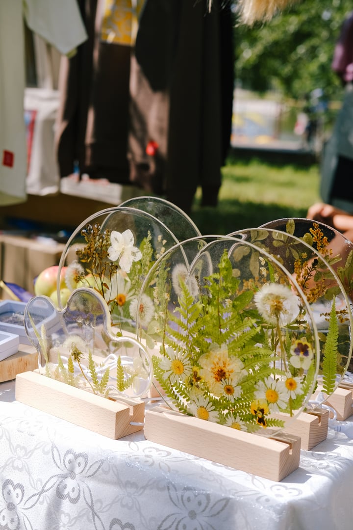 Lamps are made of epoxy resin with dry flowers inside. Handmade work. Market is in the park.